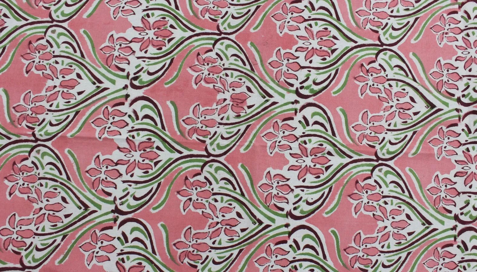 Hand block printed floral design in pink hues, perfect for tablecloths and home decor accents.