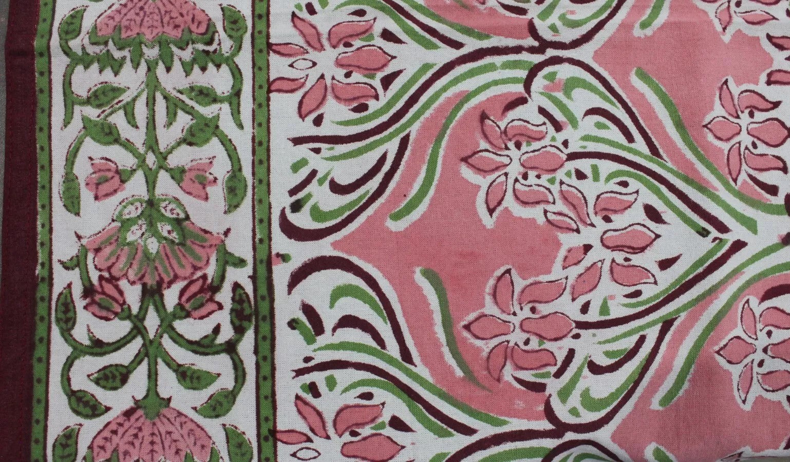 Hand block print floral design in shades of pink and green on 100% cotton table cloth, perfect for dining and decorative use.
