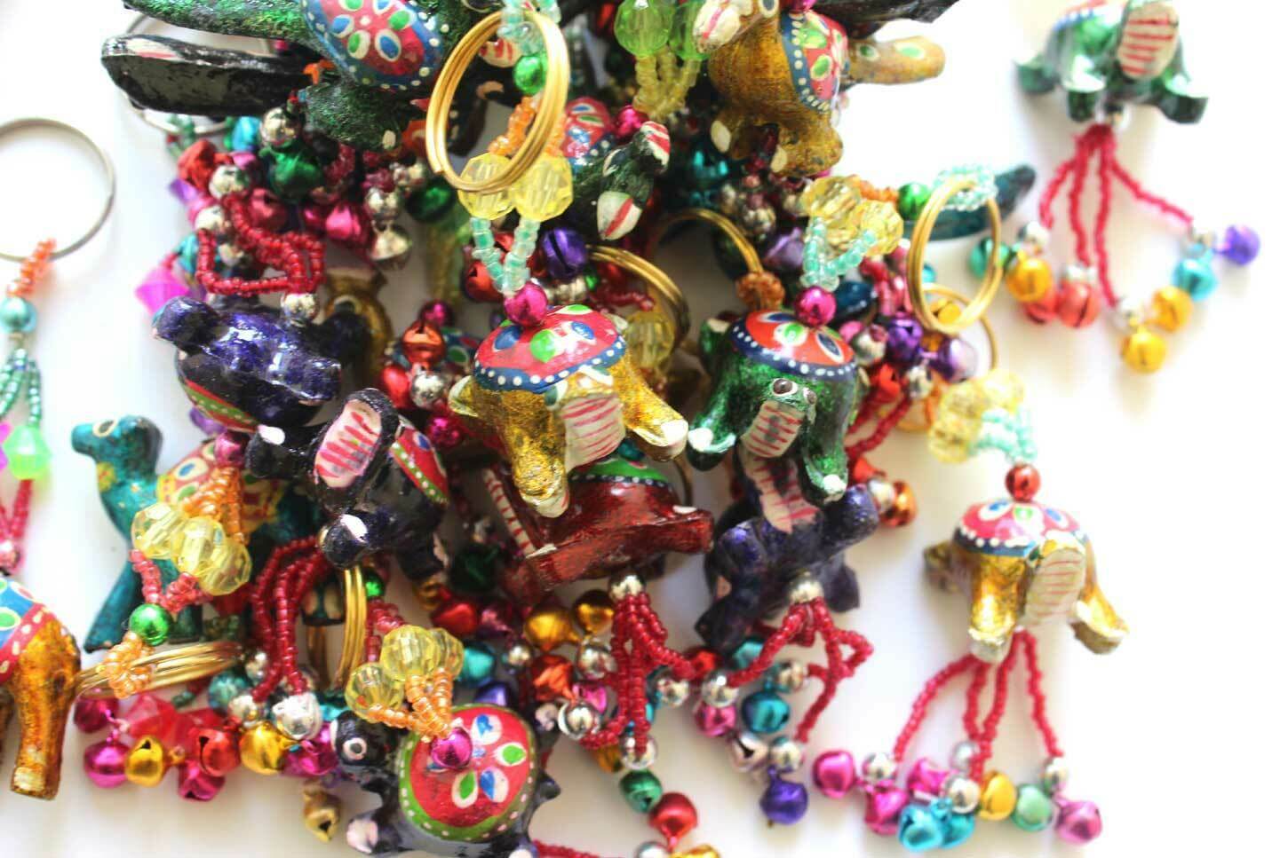 Assorted hand-painted animal key rings including elephants and tortoises, ideal for gifts and holiday decorations.