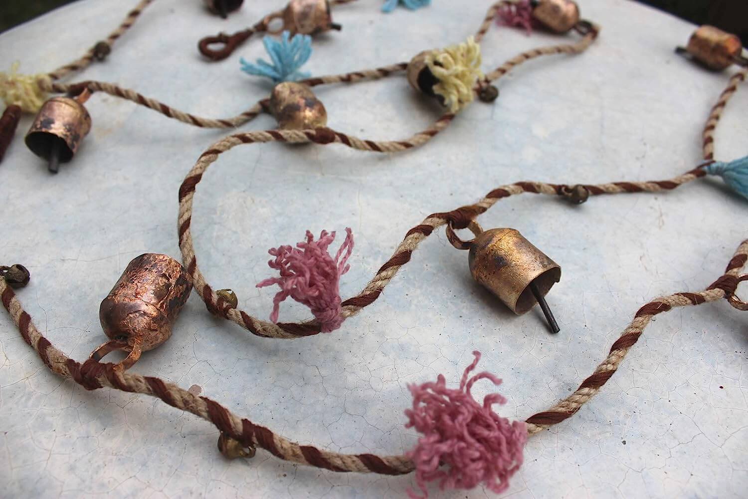 Enhance your holiday spirit with our vintage tin cow bells garland. Perfect for indoor and outdoor decoration! 5 pieces with jute rope included.