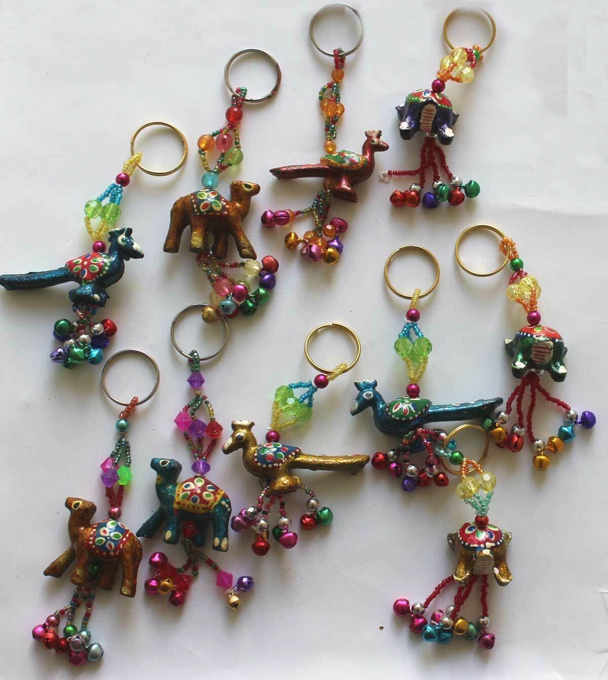 Vibrant assortment of hand-painted animal key rings: elephant, parrot, tortoise, camel, and peacock designs, perfect for gifts.