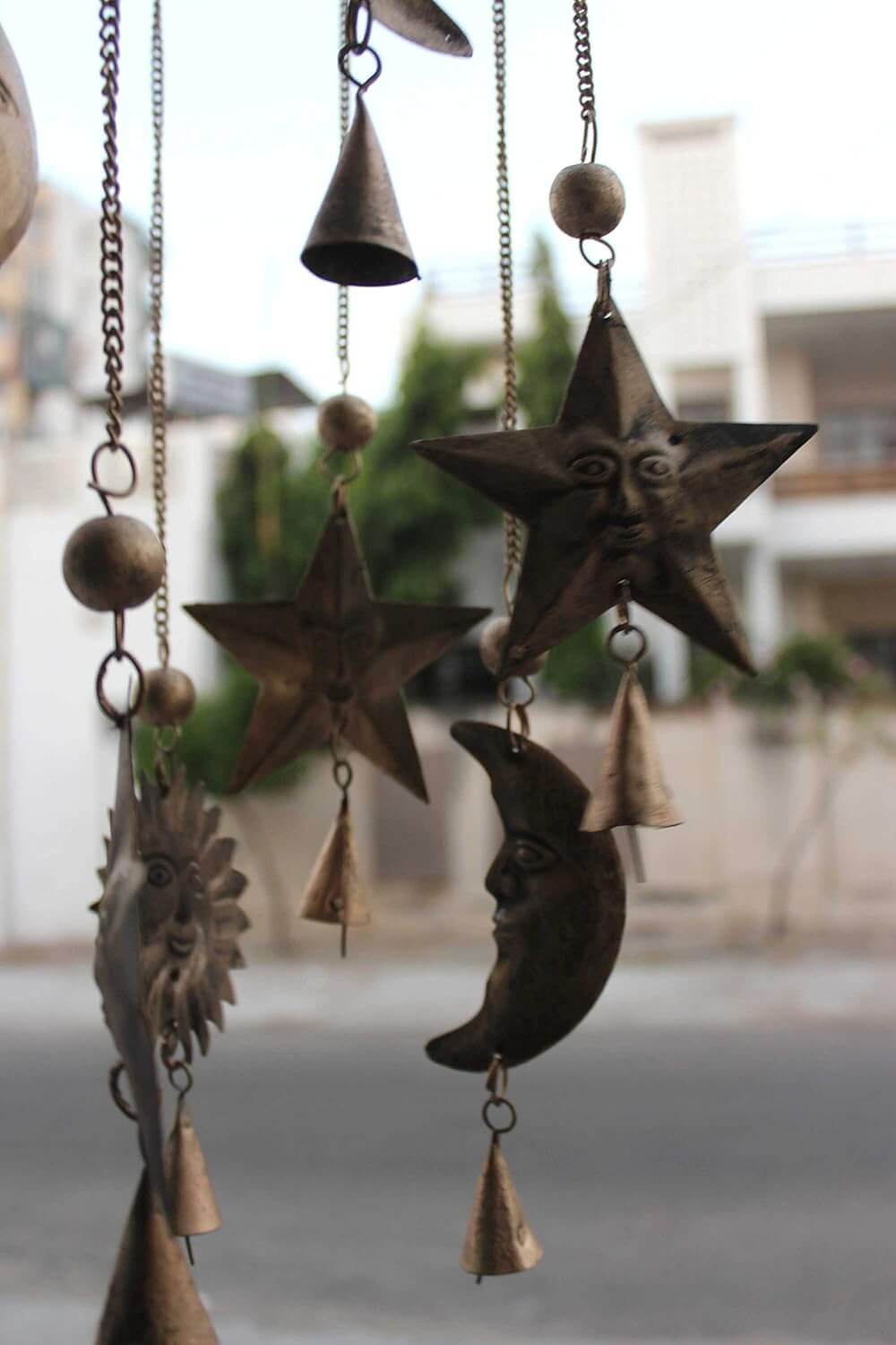 Antique look sun moon wind chime with rustic bells, perfect for outdoor decor and garden ornaments.
