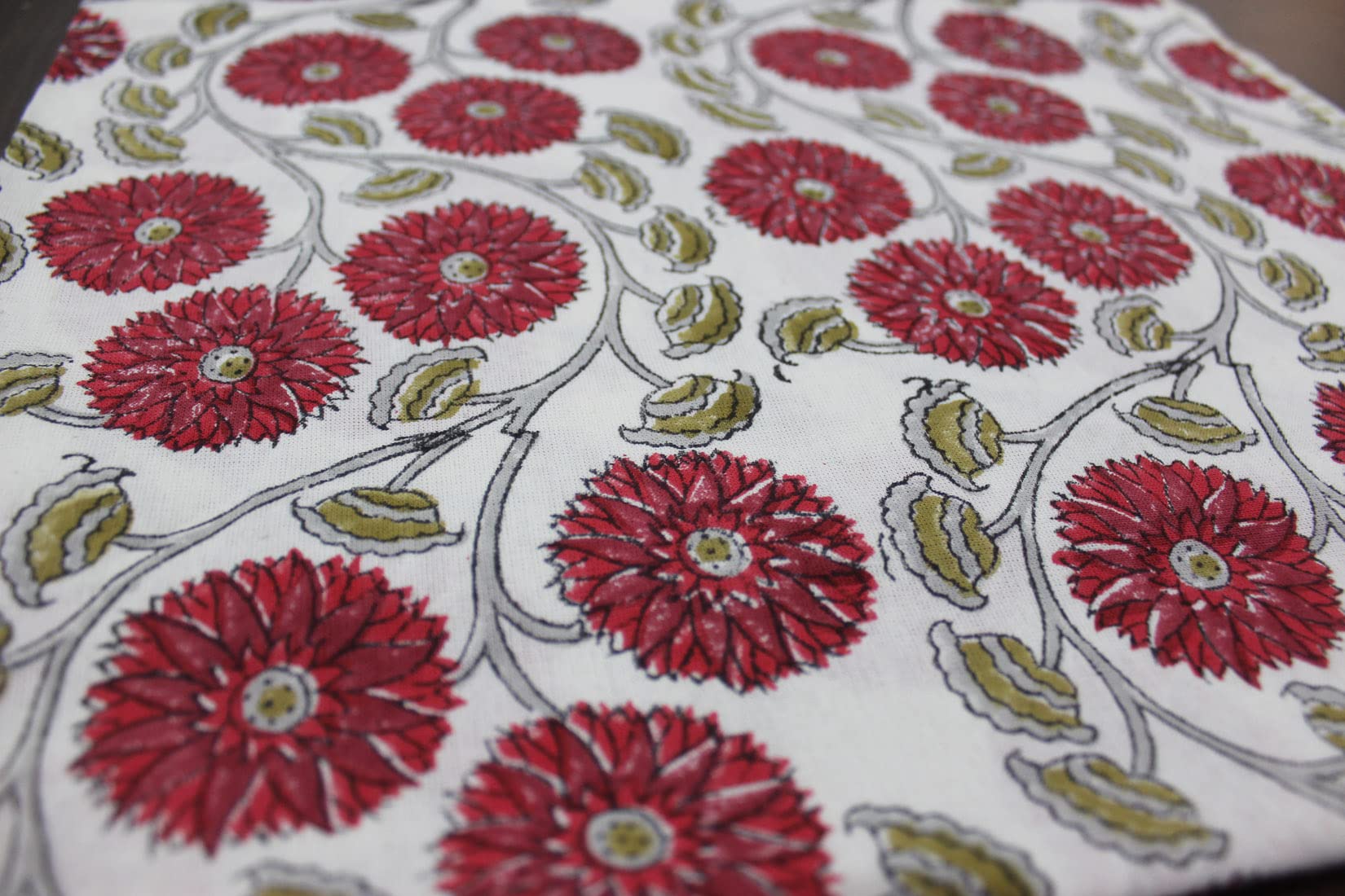 Red and white floral hand block print tablecloth showcasing vibrant flowers, ideal for dining and festive occasions.