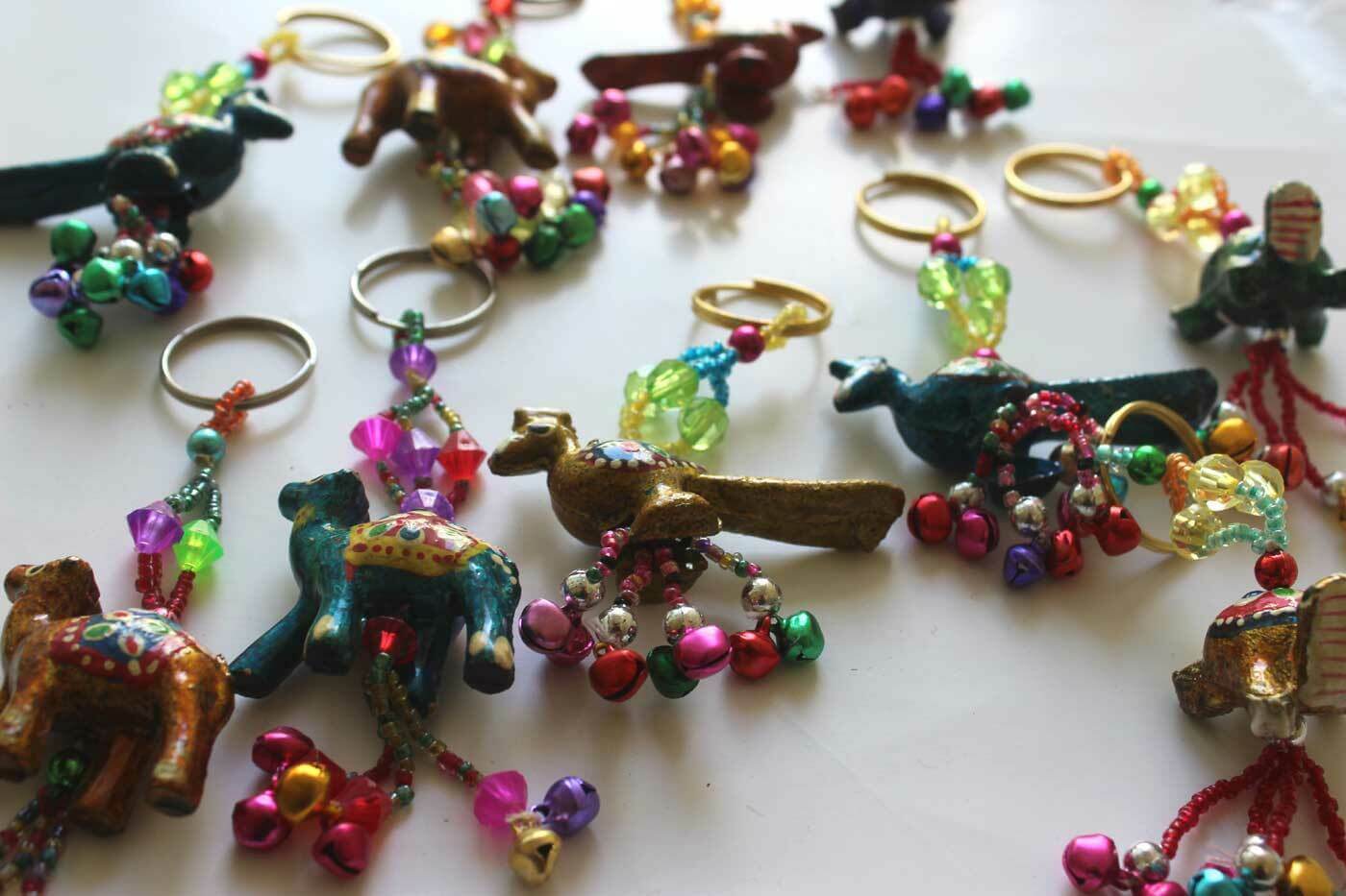 Hand painted animal key rings featuring elephants, birds, and other designs, perfect for gifts and X-mas ornaments.