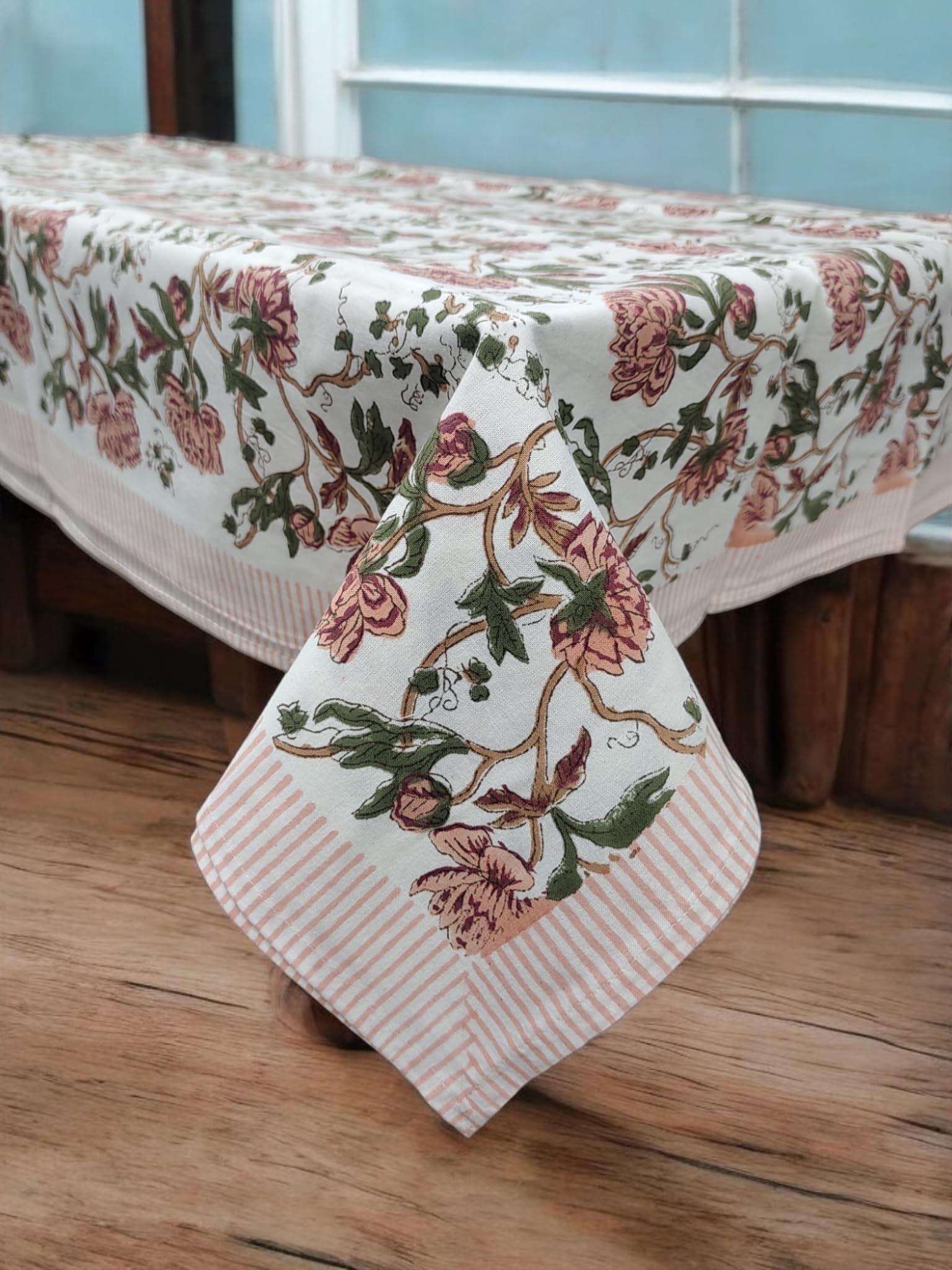 White floral hand block print tablecloth on a wooden dining table, perfect for spring and summer decor.