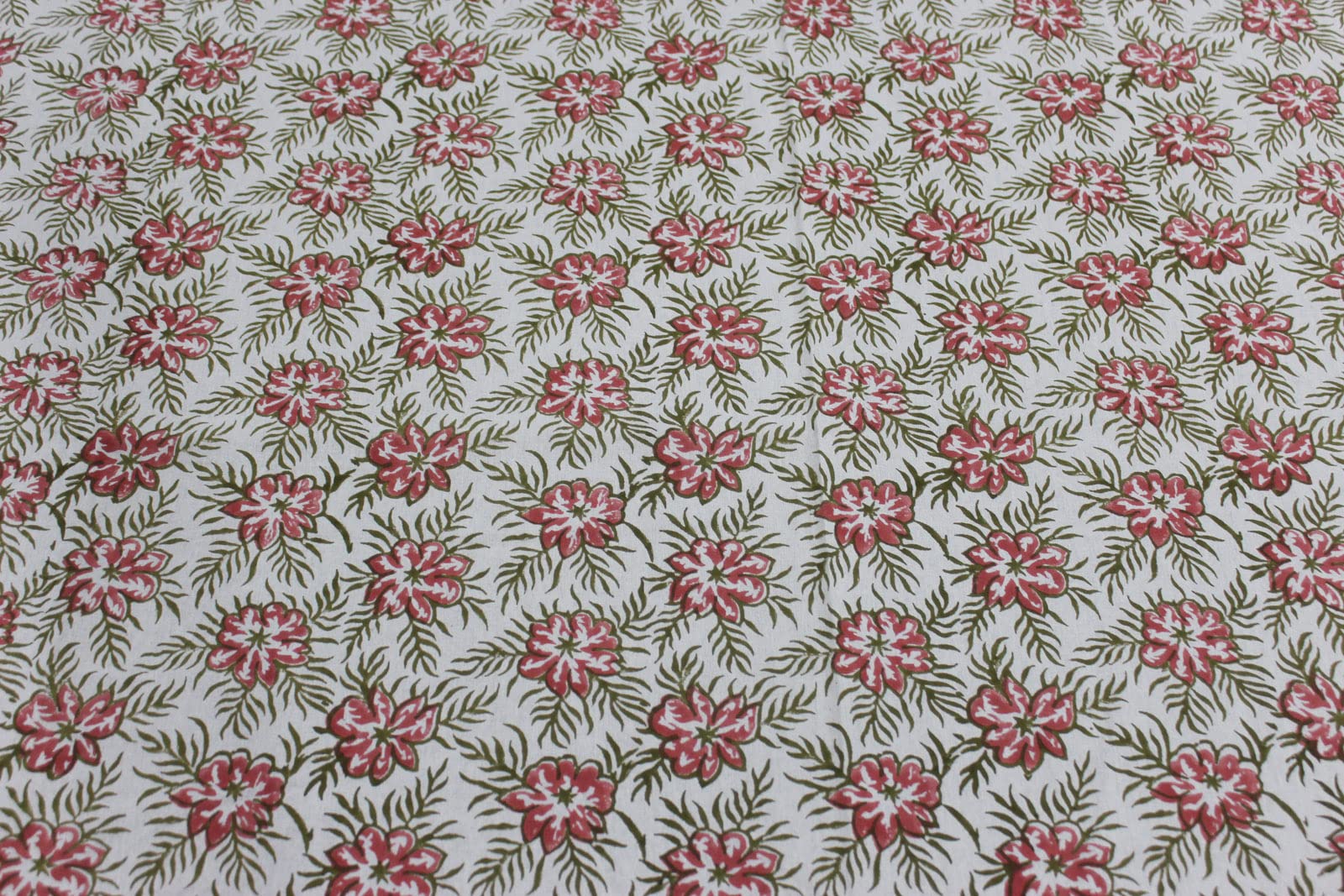 Pink floral hand block print tablecloth pattern on white background, perfect for dining and festive occasions.
