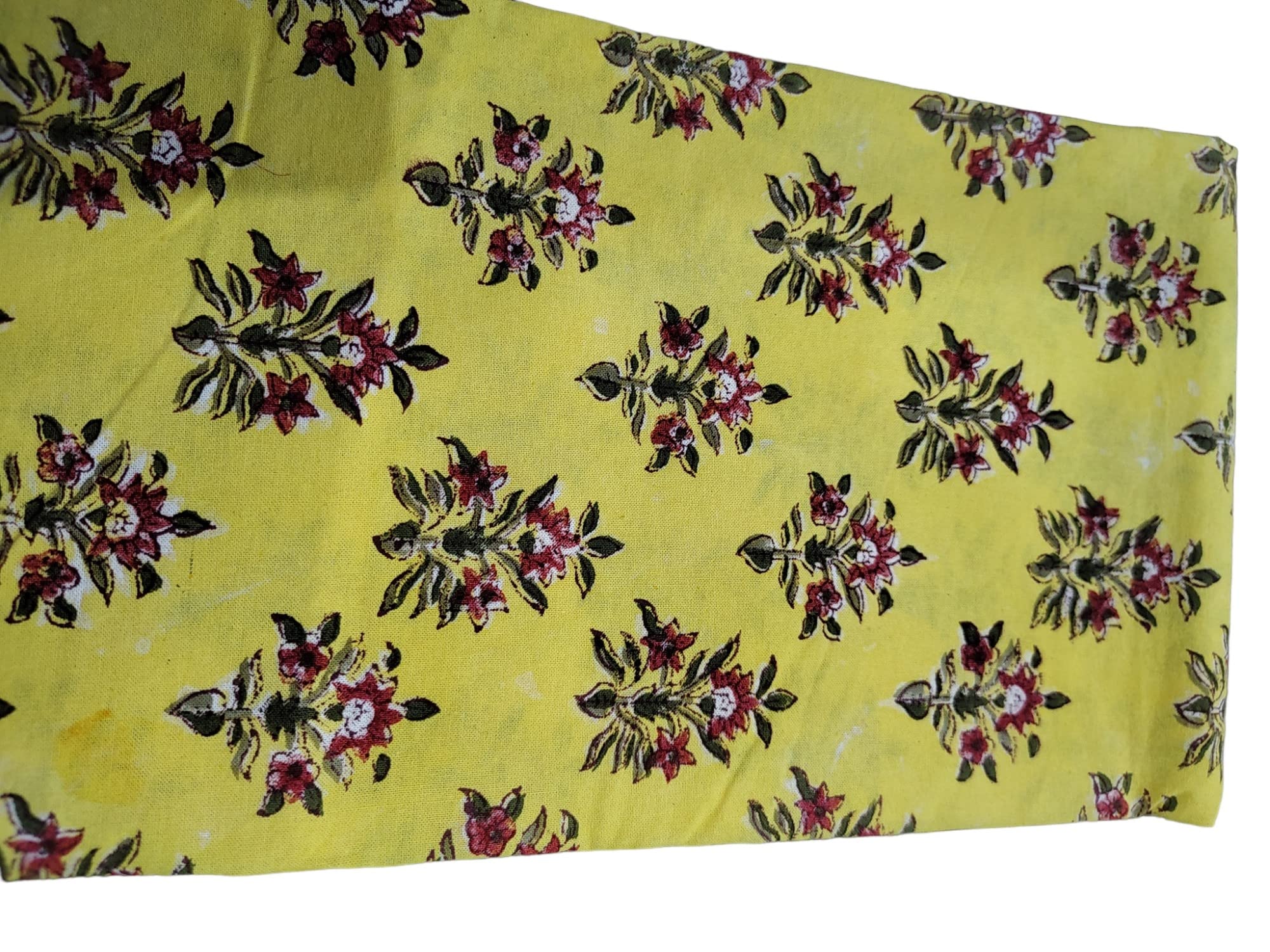 Vibrant yellow floral hand block print fabric featuring intricate red and green flowers, perfect for tablecloths and decor.