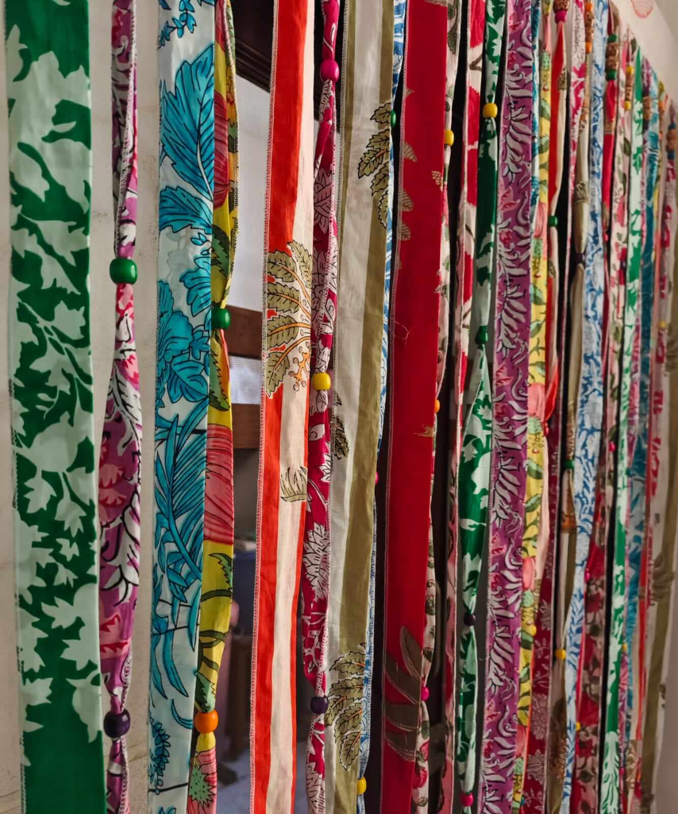 Bohemian Hippy Beaded Doorway Garland showcasing multicoloured cotton fabric ribbons and decorative beads.