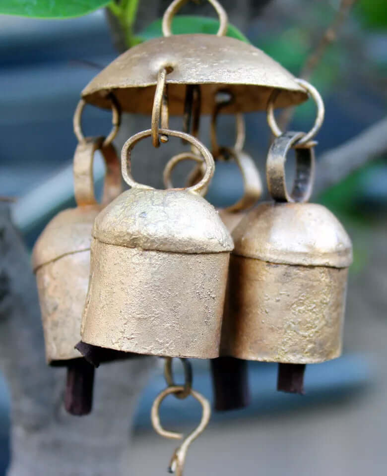 Antique gold wind chime with three rustic bells, adding charm to indoor and outdoor spaces.