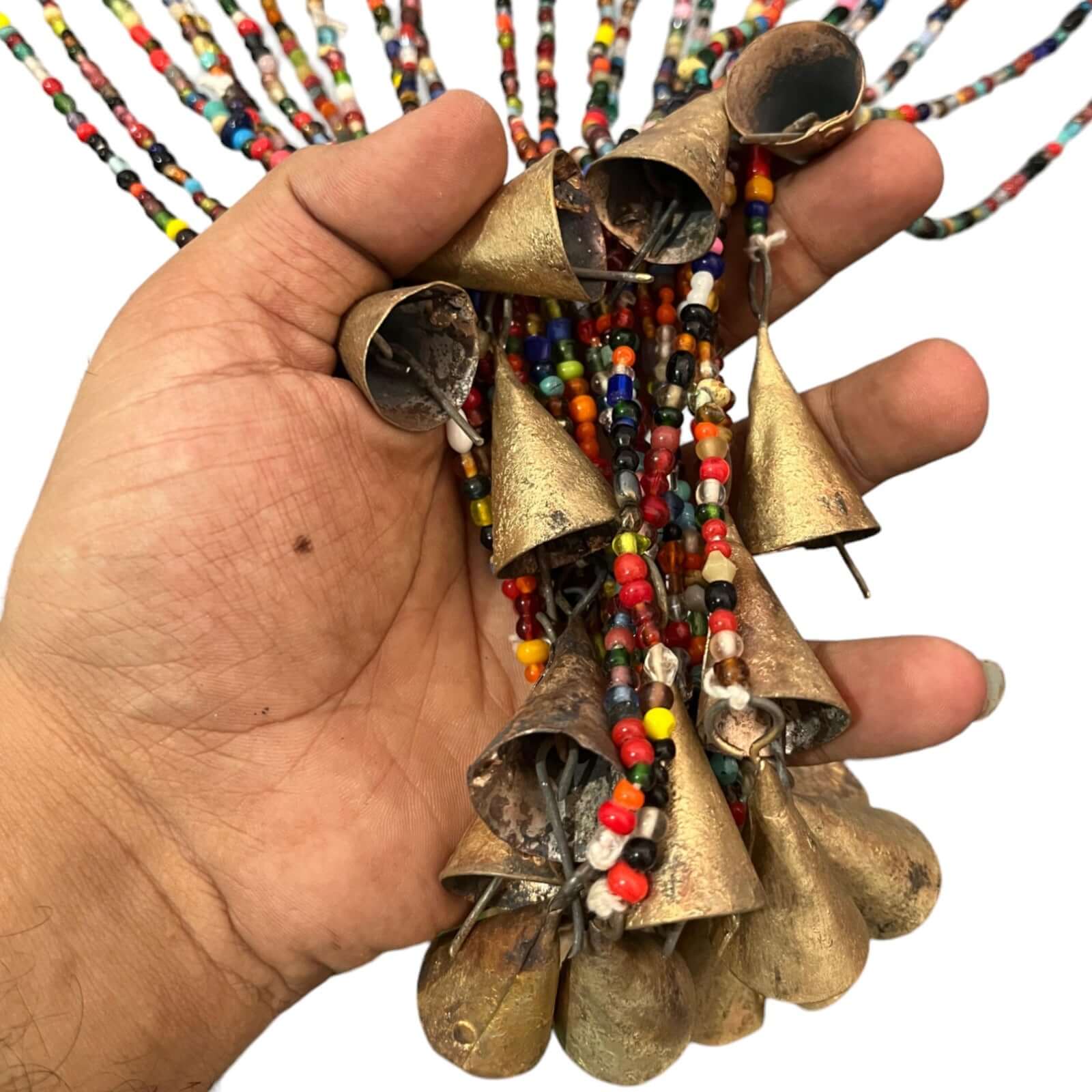Hand holding colorful bohemian glass beaded curtain strands with bells, ideal for hippie decor.