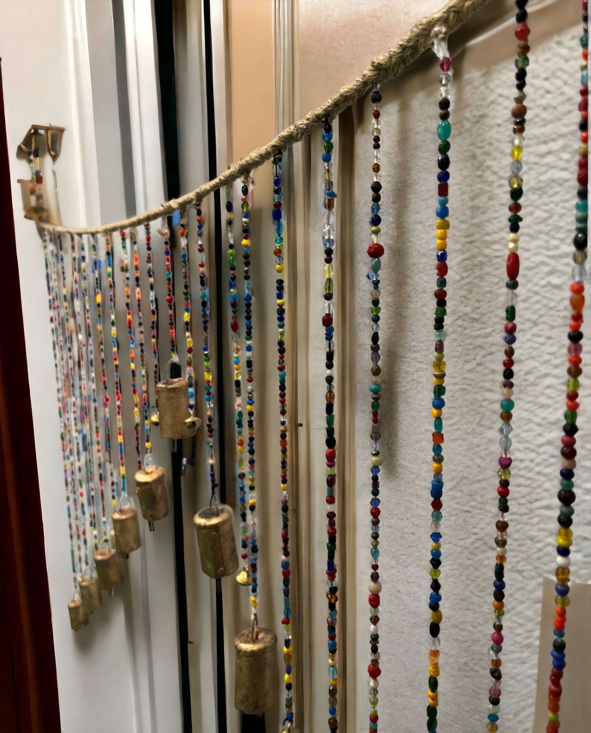 Beaded wall door hanging valance with multicolour glass beads and brass bells, bohemian style home décor.