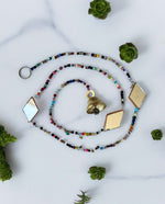 Colorful beaded curtain chain with glass beads and jingle bell, perfect for hippie home décor and doorway decoration.