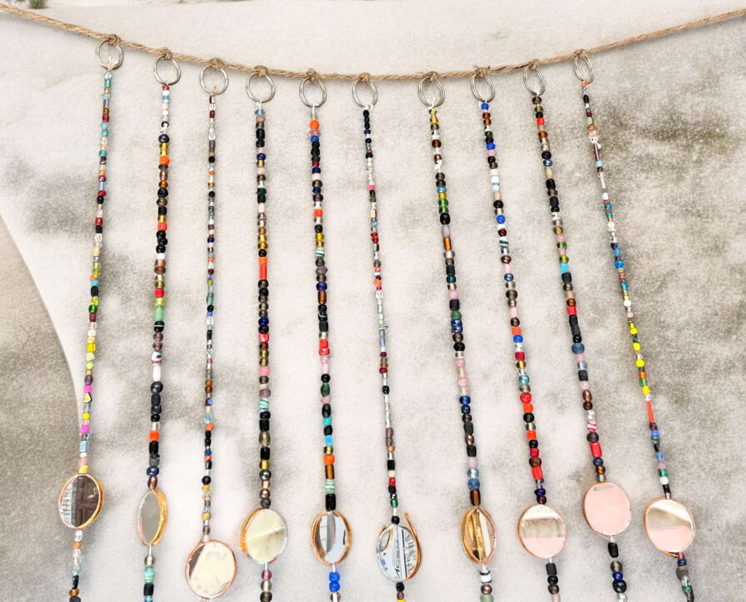 Colorful bohemian beaded curtain strands with glass beads and metal accents for hippie home decor.
