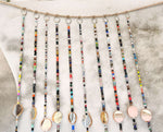 Colorful bohemian beaded curtain strands with glass beads and metal accents for hippie home decor.