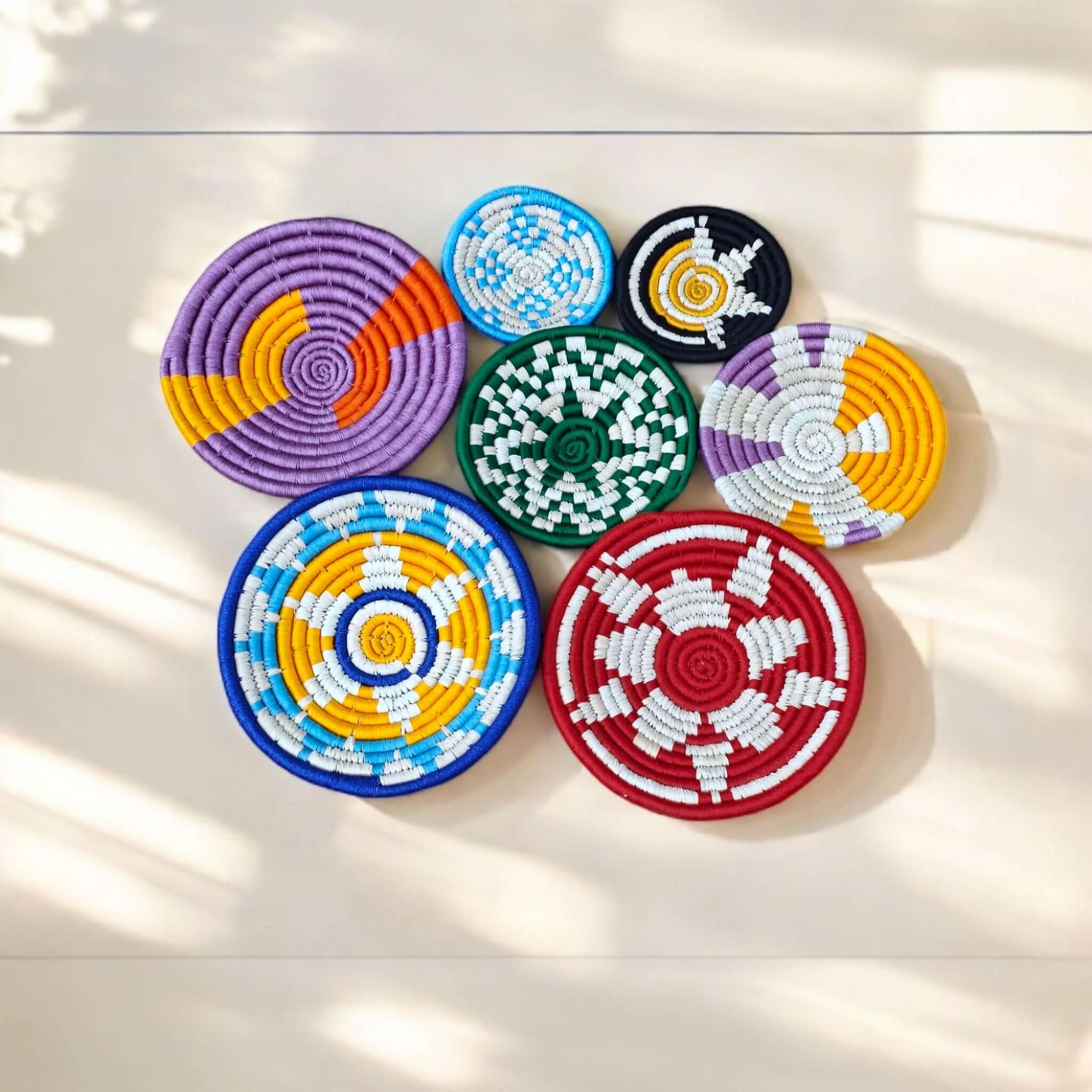Colorful handmade Sabai grass wall baskets set of 7, perfect for boho decor and eco-friendly home accents.