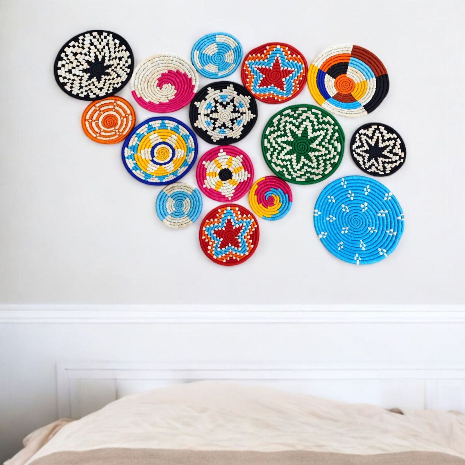 Colorful handwoven rattan wall plates in a bohemian arrangement, perfect for vintage wall decor and living room accents.