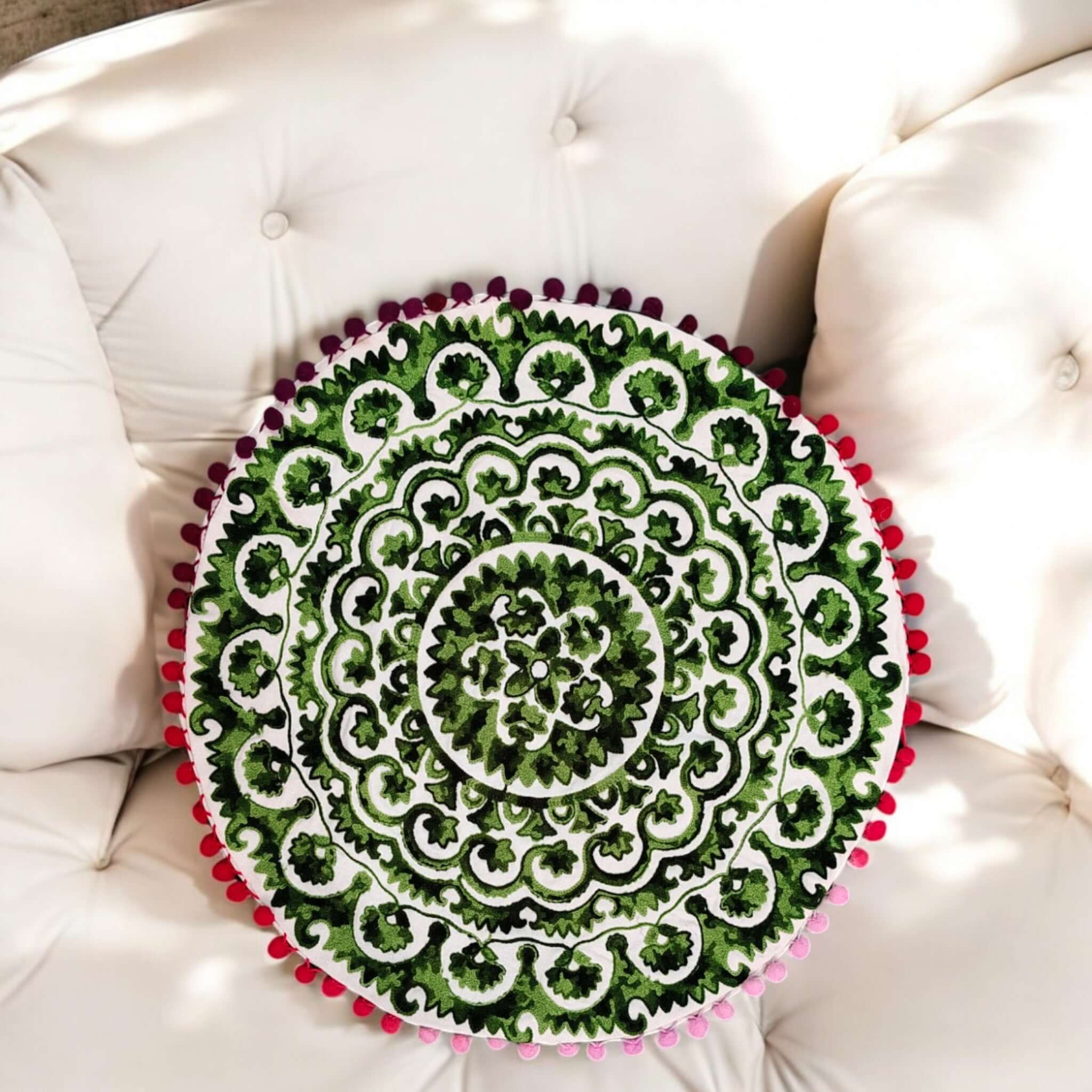 Multicolor Round Floral Paisley Printed Cushion Covers on a beige sofa, featuring intricate designs and vibrant colors.