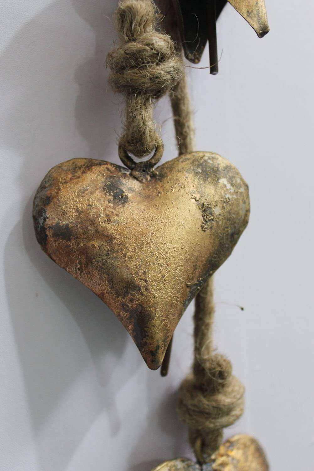 Antique rustic metal heart wall art, handcrafted from recycled iron, eco-friendly decor for boho home styling.