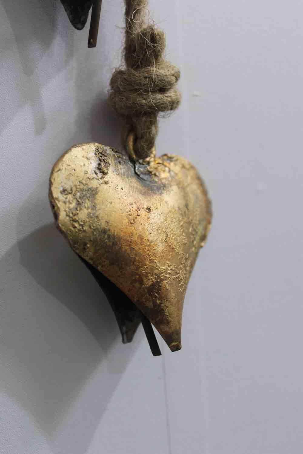 Handcrafted metal heart wall decor with rustic finish, eco-friendly, perfect for boho home decor.