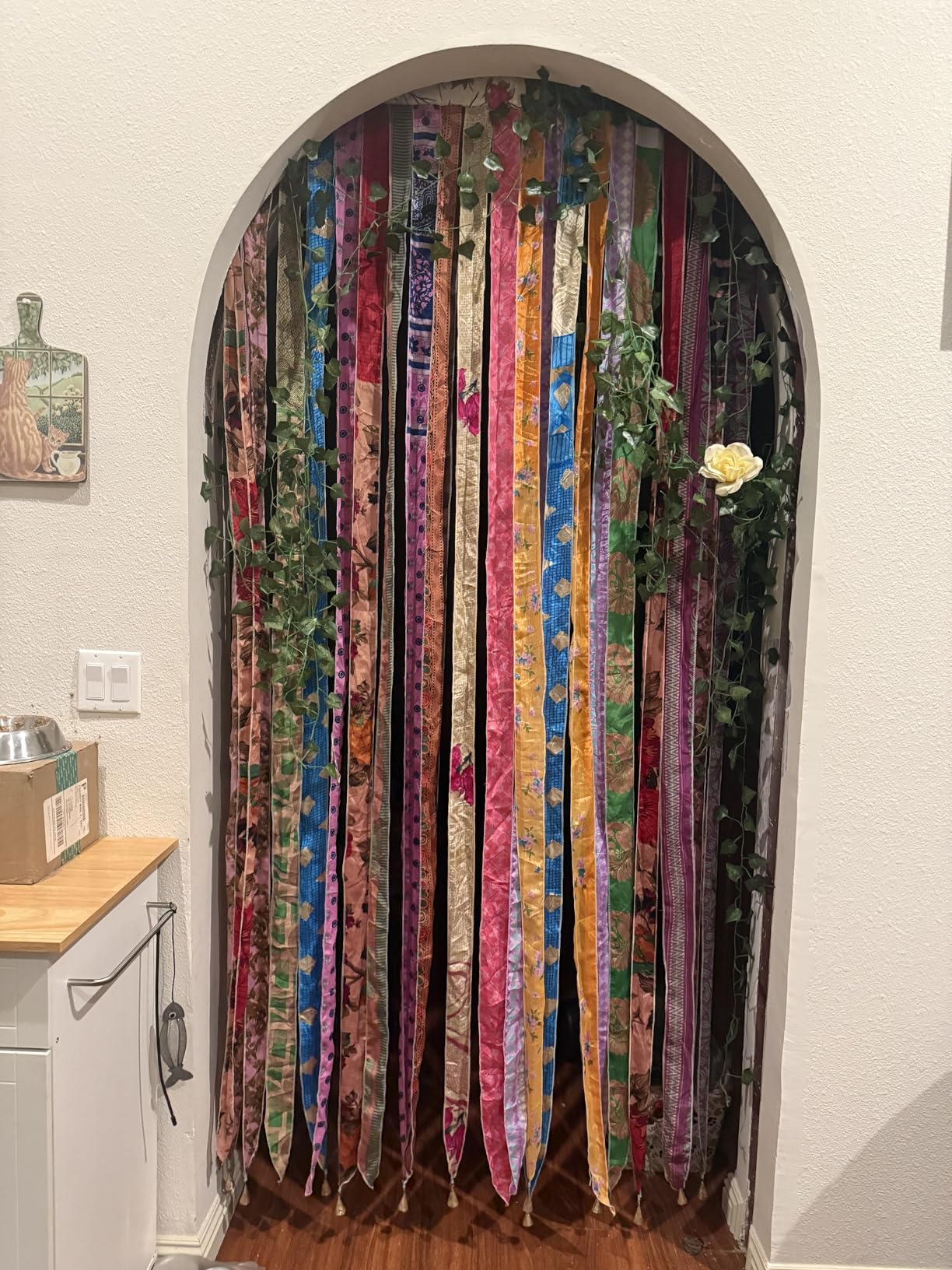 Colorful fabric strips hanging in an archway
