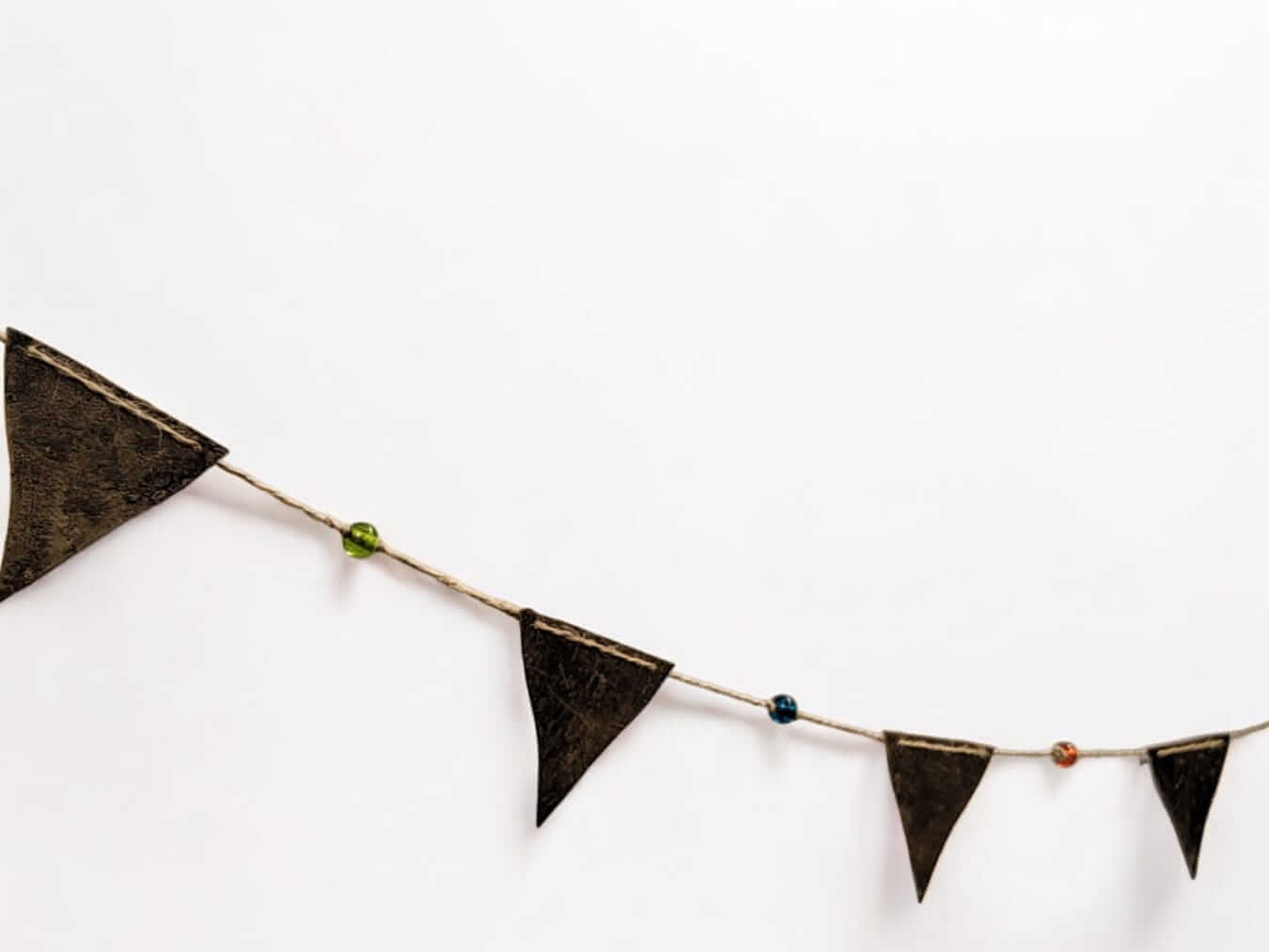 Recycled iron triangle bunting garland with multicolor glass beads for bohemian party decor.