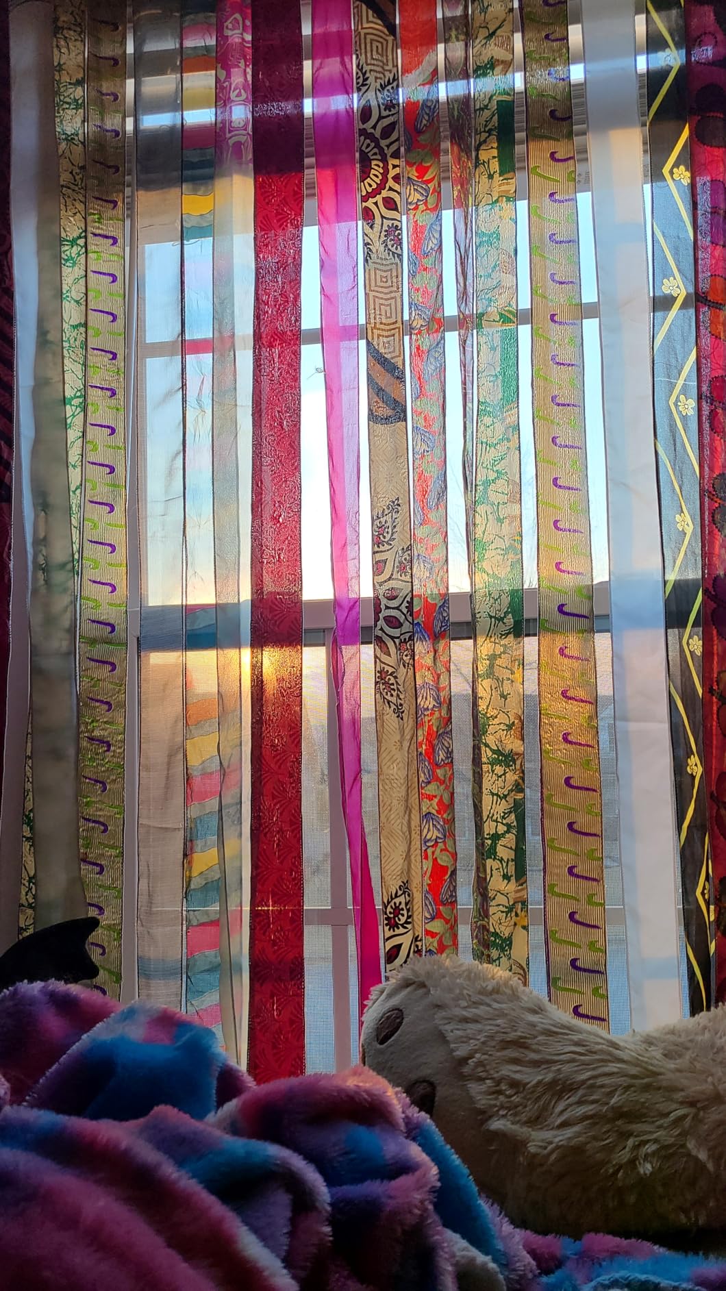 Colorful striped curtains with decorative patterns in front of a window