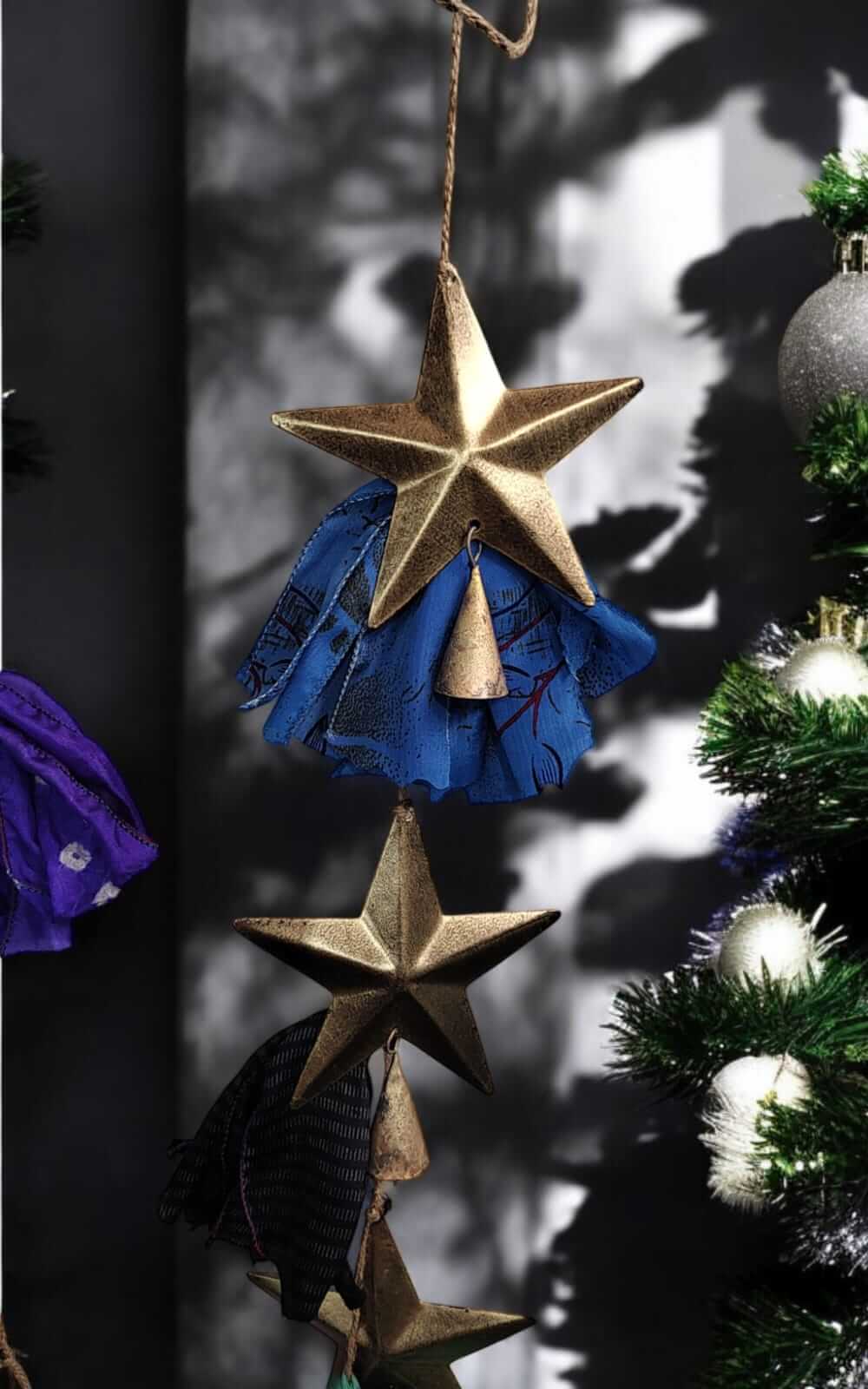 Handmade upcycled silk sari garland with gold metal stars and bells, perfect for bohemian X-Mas and garden décor.