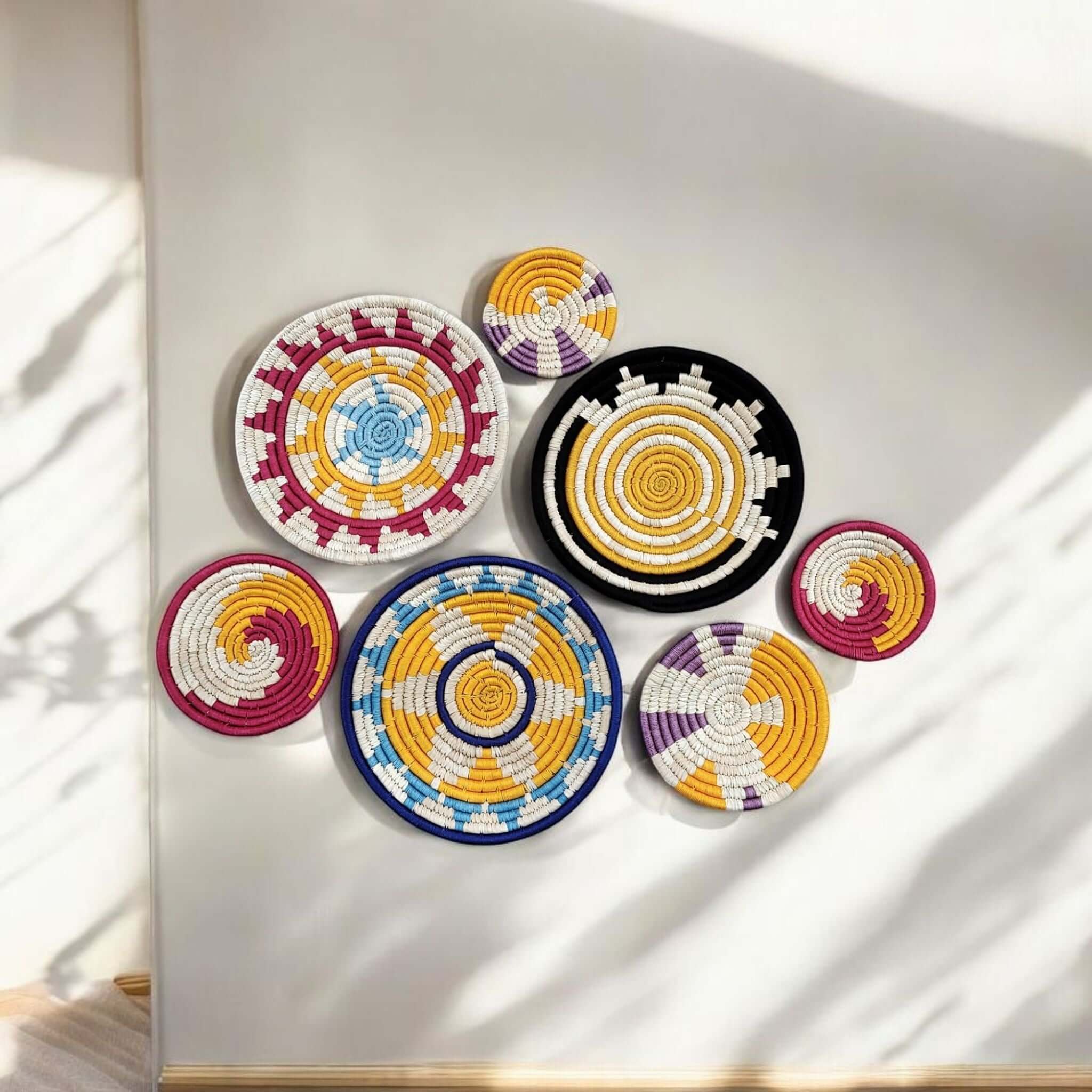 Colorful handmade wall baskets in a bohemian arrangement, adding charm to indoor decor.