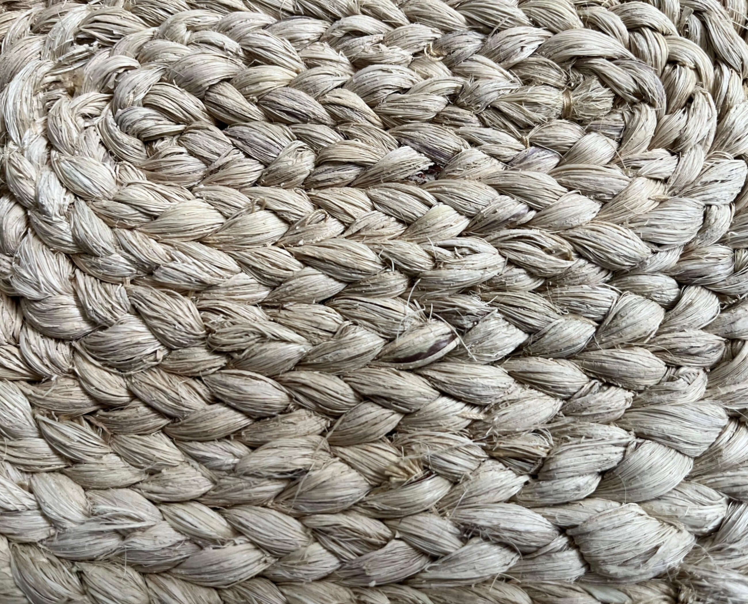 Close-up of handwoven natural placemats made from eco-friendly materials, showcasing rustic and stylish design.