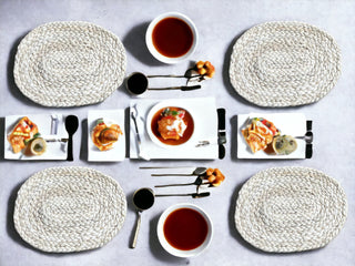 Handwoven natural placemats set on a dining table with stylish dishware and tea, showcasing sustainable elegance.