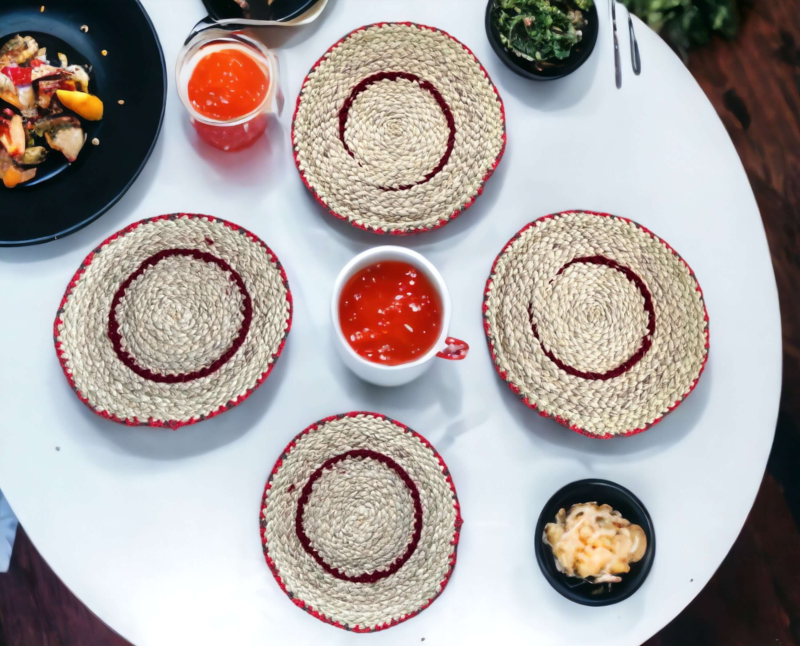 Handwoven banana fiber placemats on a dining table with bowls and dishes, showcasing eco-friendly rustic decor.