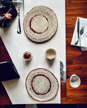 Handwoven banana fiber placemats on a dining table, showcasing their eco-friendly and rustic charm.