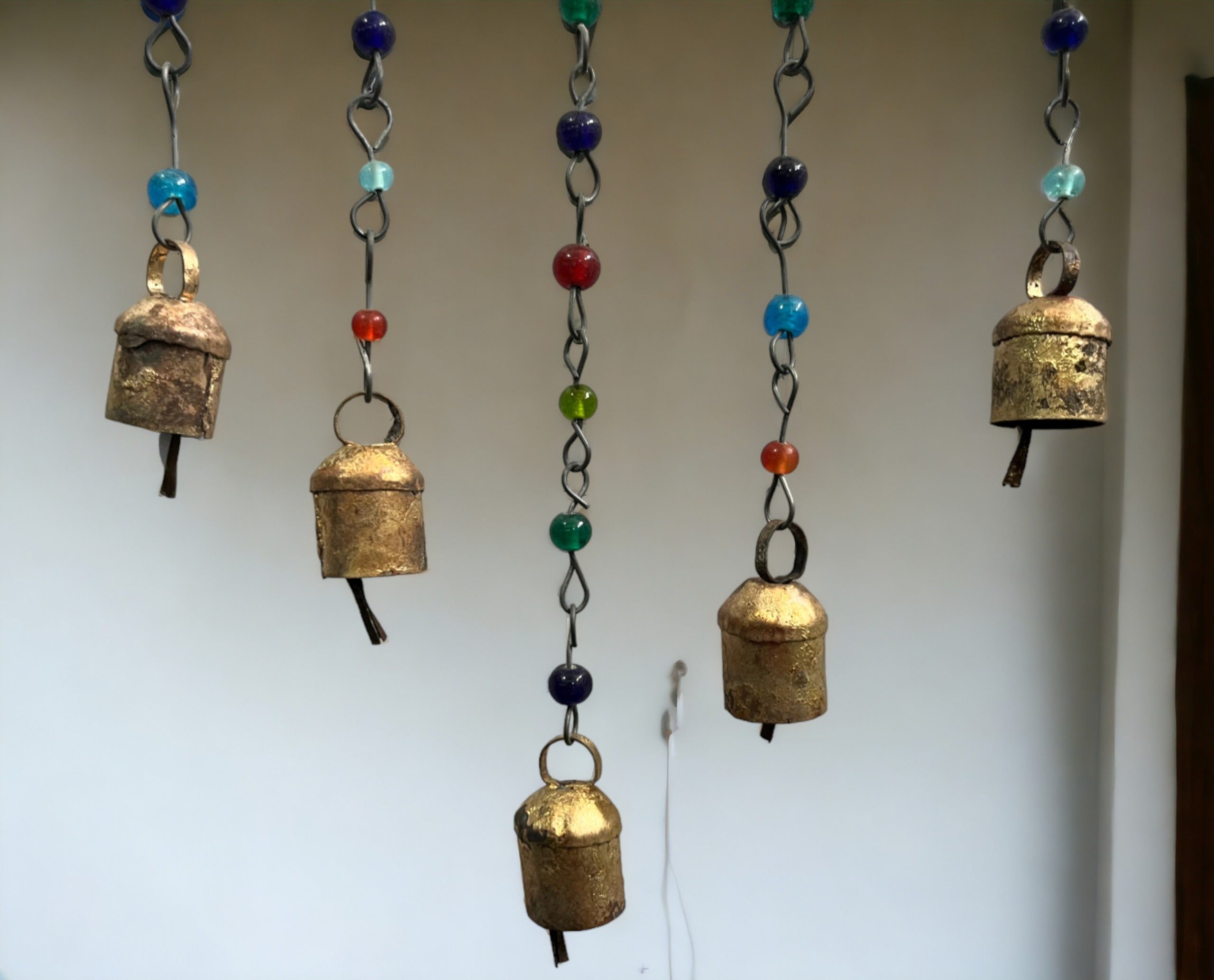 Colorful handmade beaded iron wind chimes with decorative metal bells, perfect for bohemian decor and suncatchers.