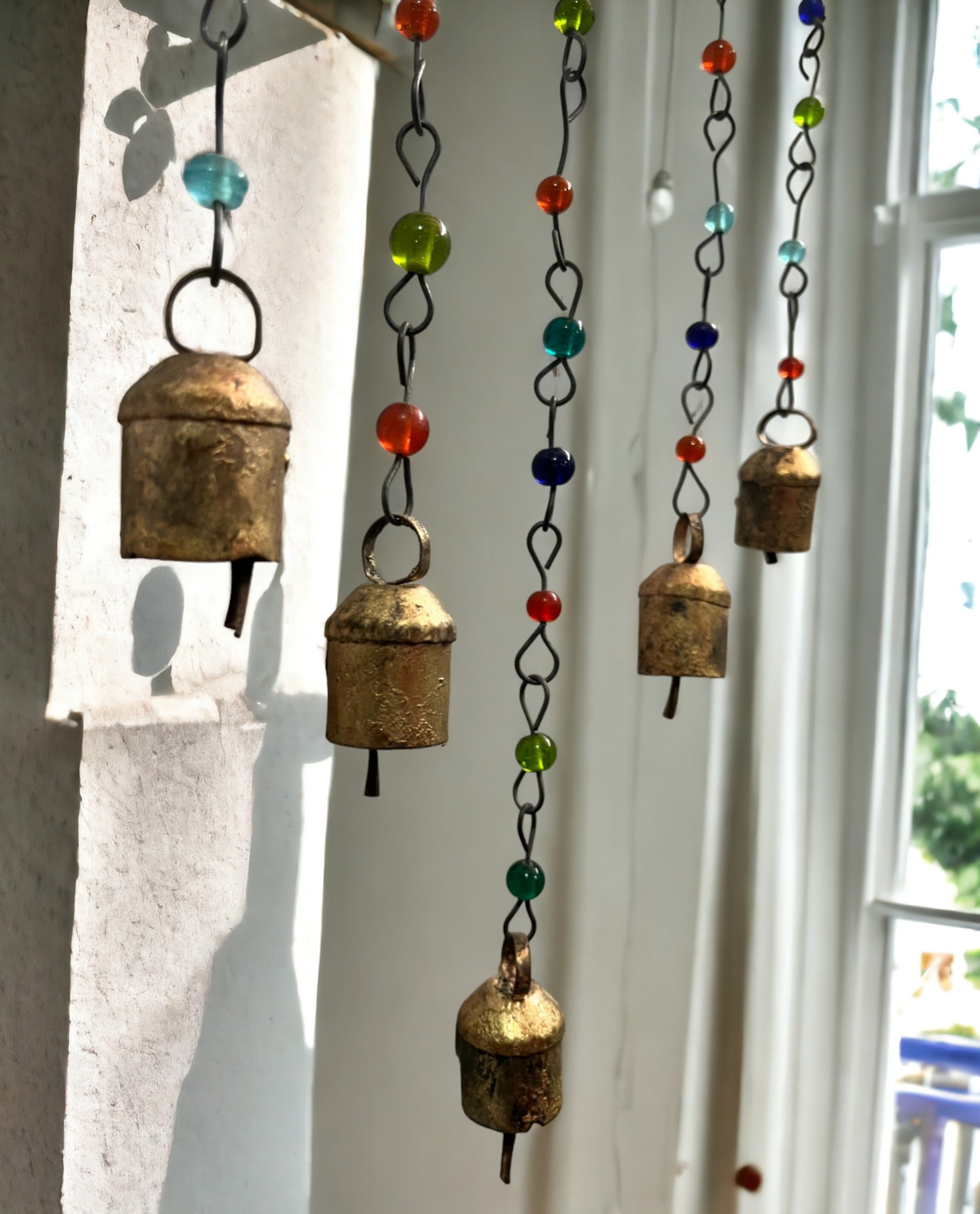 Handmade beaded iron wind chimes featuring decorative bells in assorted colors, ideal for boho home decor.