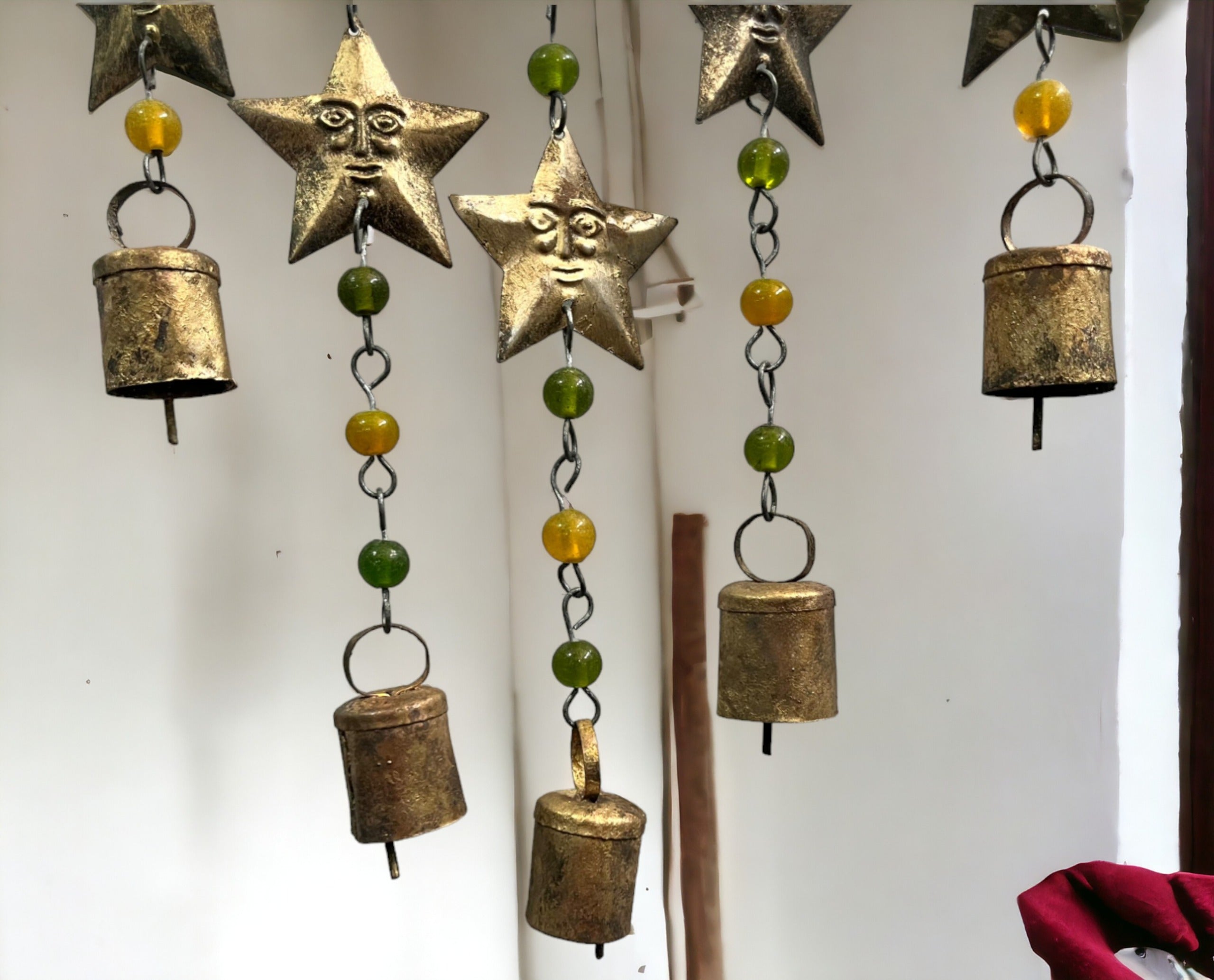 Beaded iron wind chime featuring star, sun, and moon designs with colorful glass beads hanging decoratively.