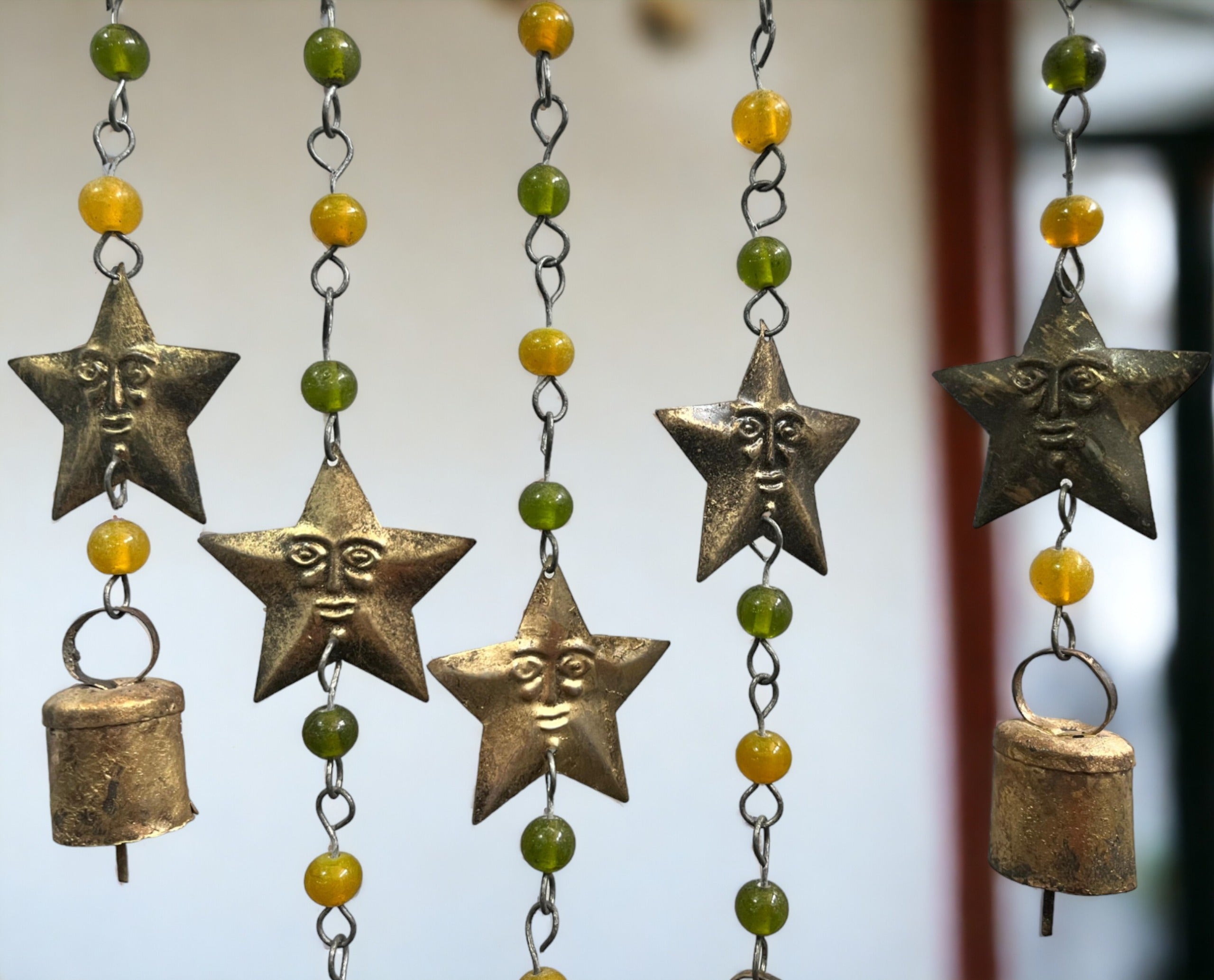 Handmade beaded iron wind chime featuring star designs and decorative bells for boho decor.