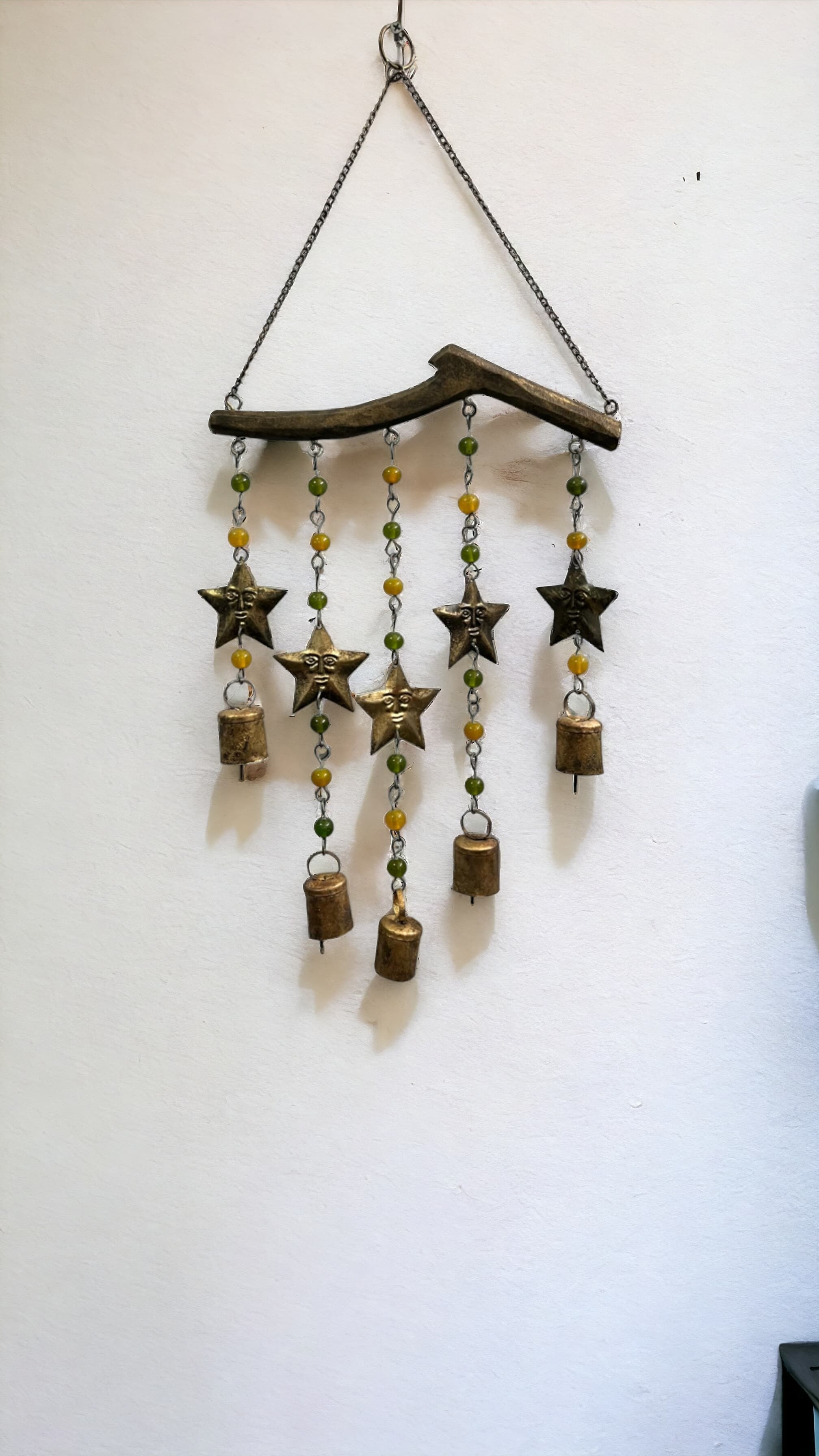 Handmade beaded wind chime featuring star designs and decorative bells, perfect for boho home decor.