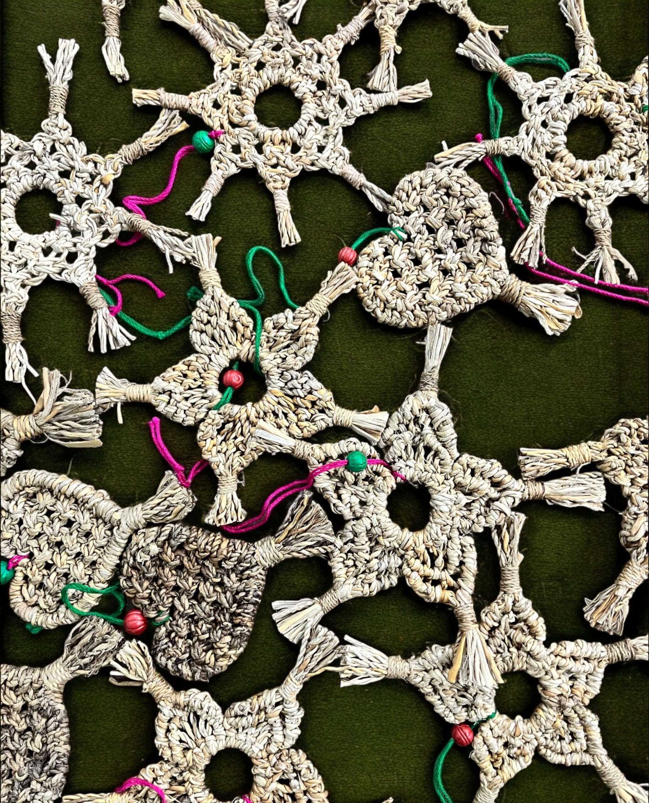 Handwoven star and heart ornaments made from banana fiber, ideal for Christmas tree decoration, showcasing unique designs.