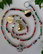 Colorful beaded curtain chain with metal bells, perfect for hippie home decor and doorway accents.