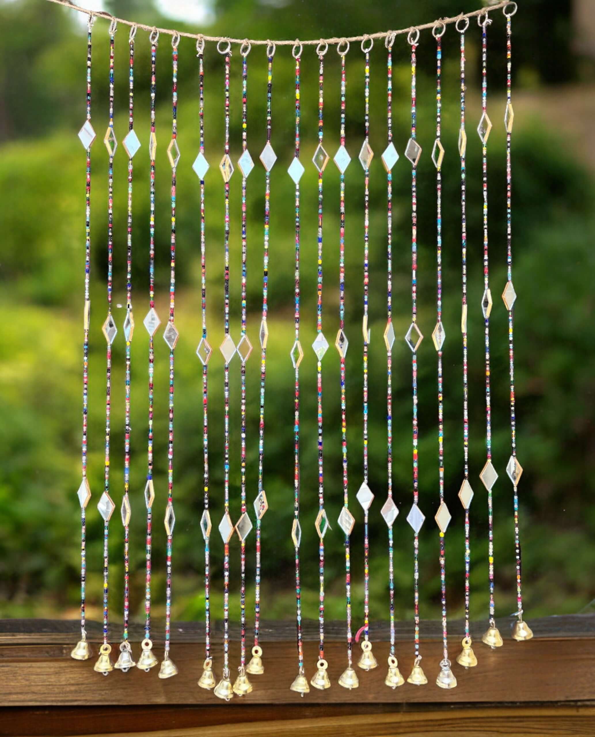 Colorful Bohemian curtain with glass beads and metal bells for doorways and wall decor, 40 inches long.