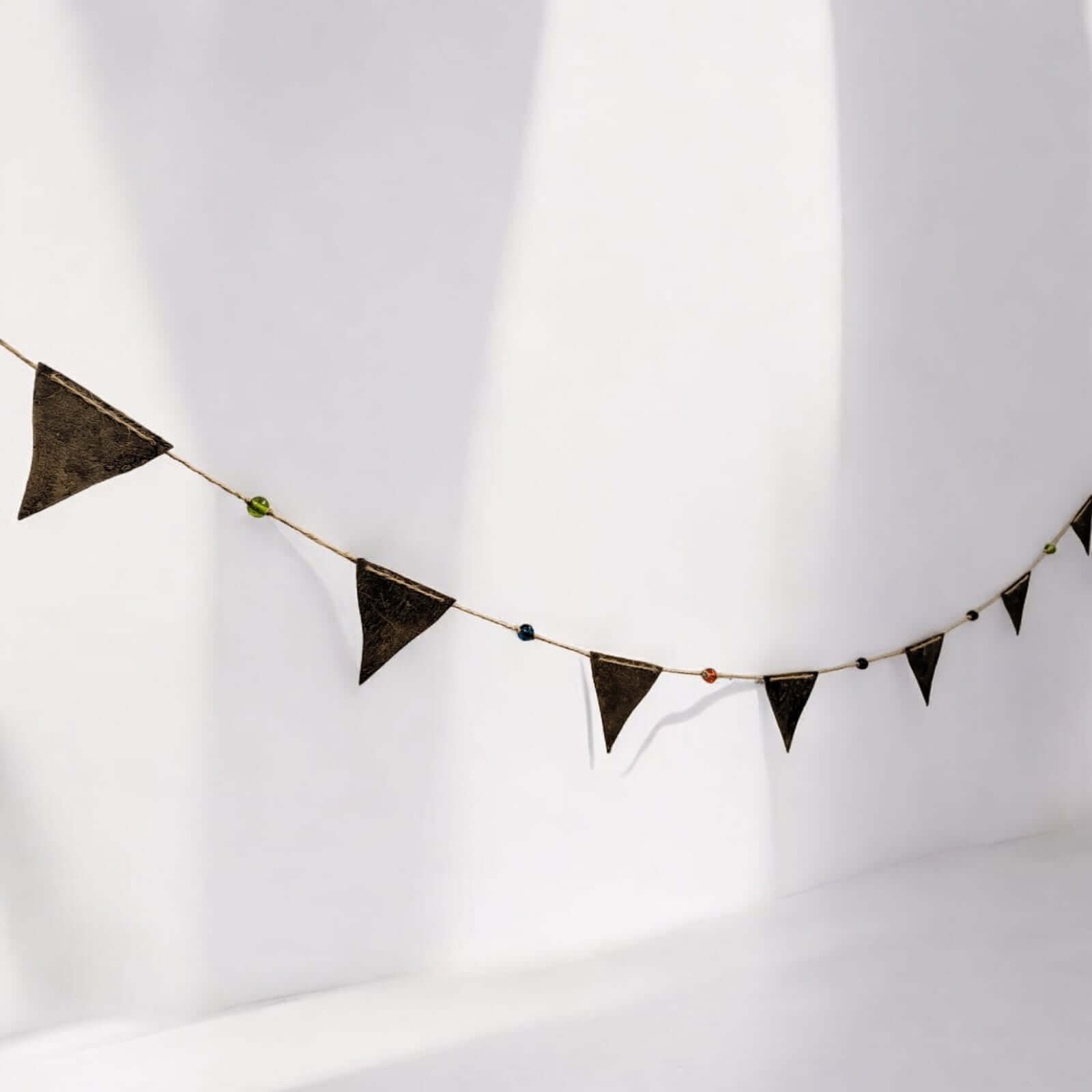 Recycled iron metal triangle bunting garland with multicolour glass beads, perfect for bohemian-themed indoor and outdoor décor.