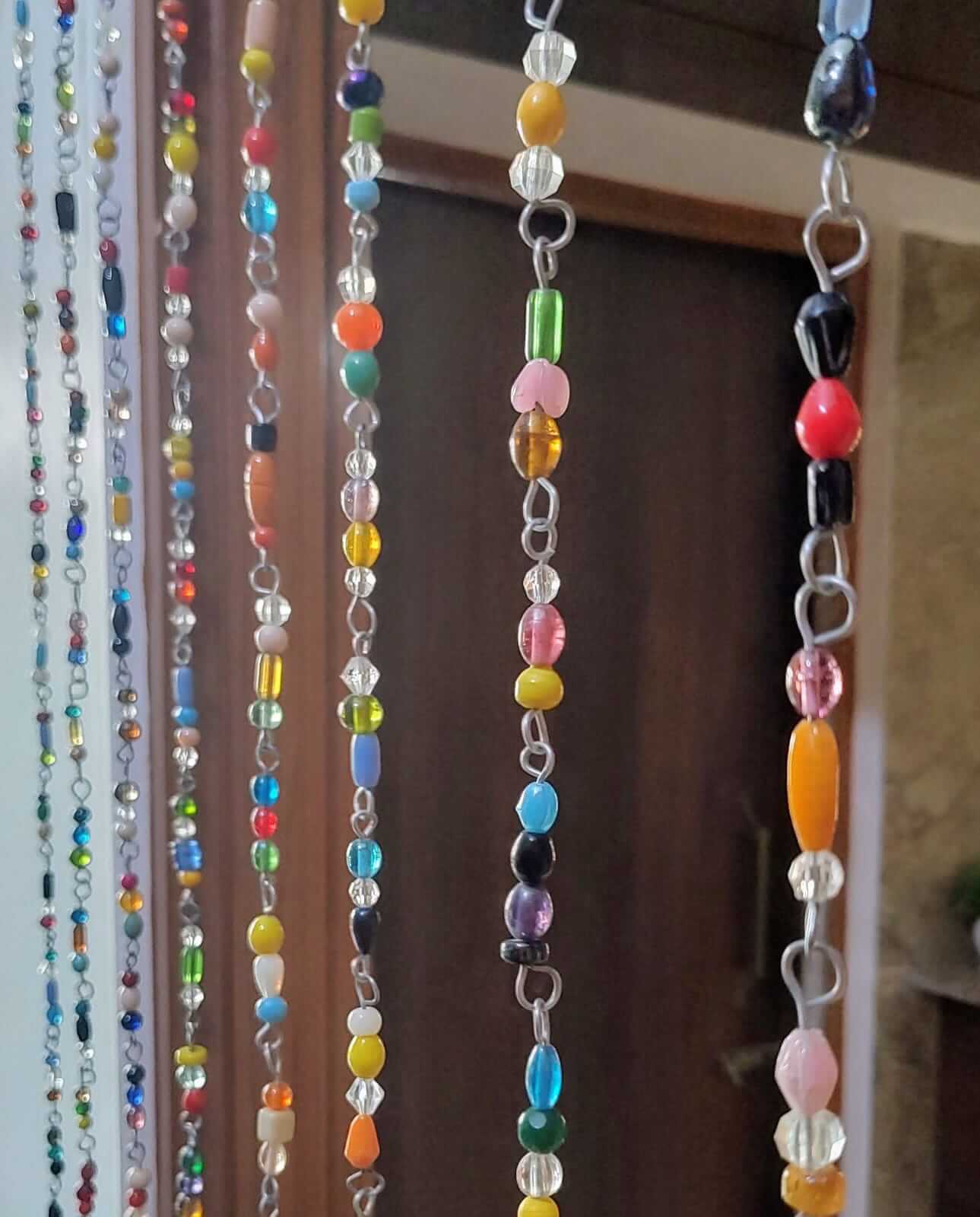 Colorful glass bead strands for bohemian beaded curtain, perfect for doorways and sun catchers, handmade and eco-friendly.