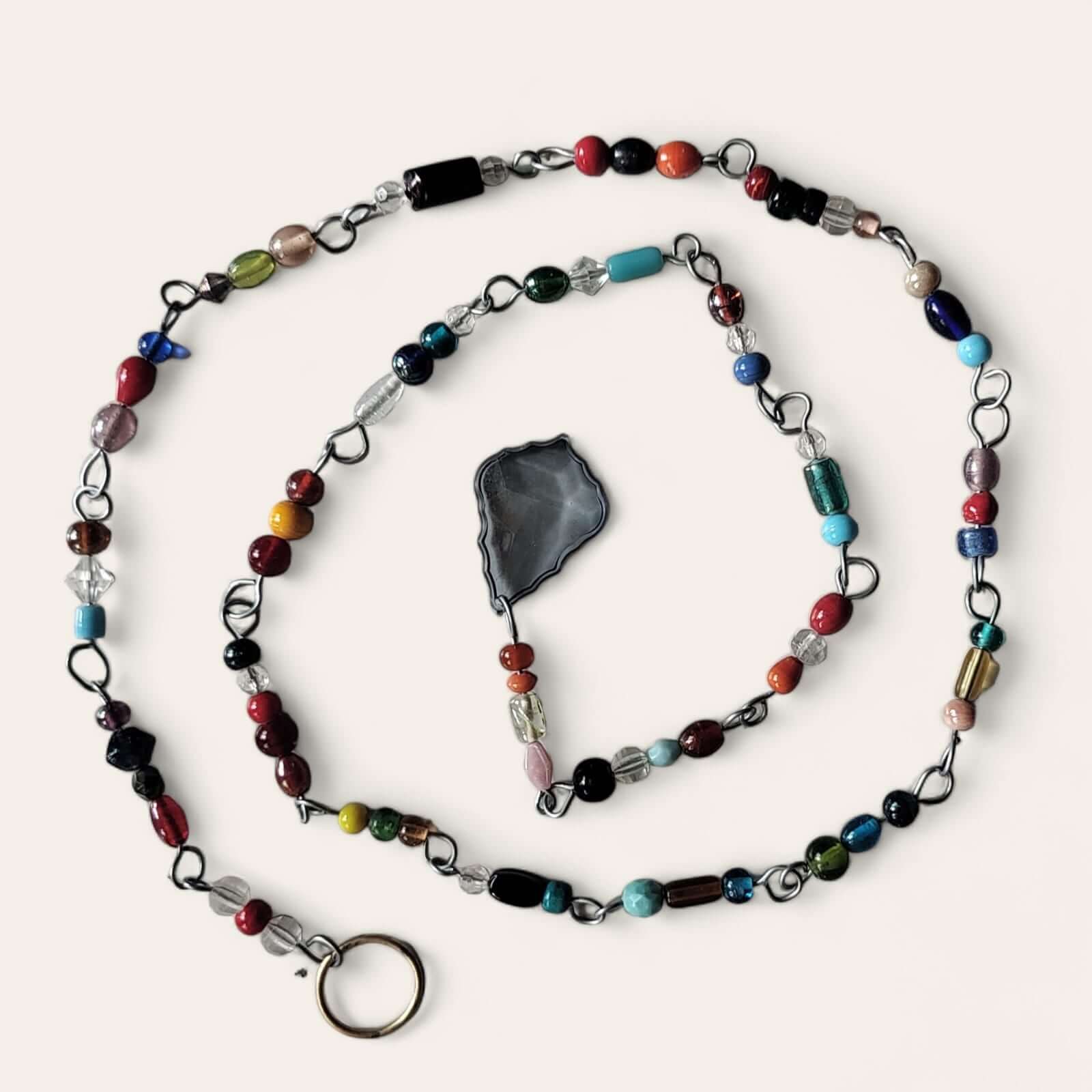 Colorful glass bead and metal chain strand, perfect for bohemian beaded curtains and hippie decor.