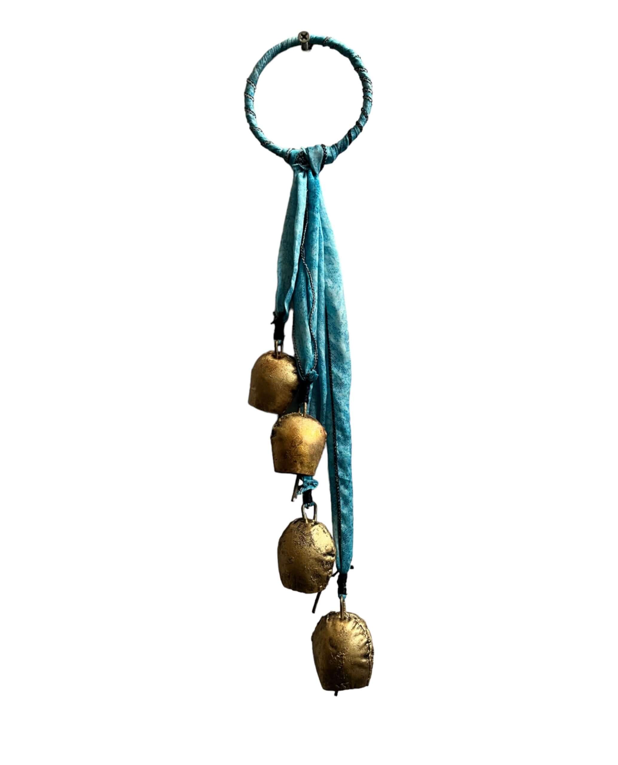 Handmade evil eye metal Christmas bell ornament with turquoise fabric, featuring 100% recycled materials and tinkling sound.