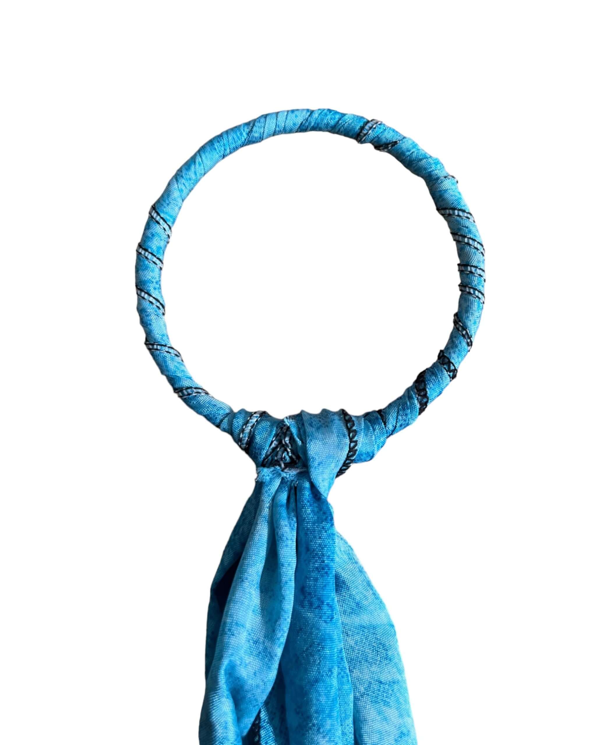 Handcrafted blue metal ring door hanger with silk sari fabric for bohemian holiday decor.