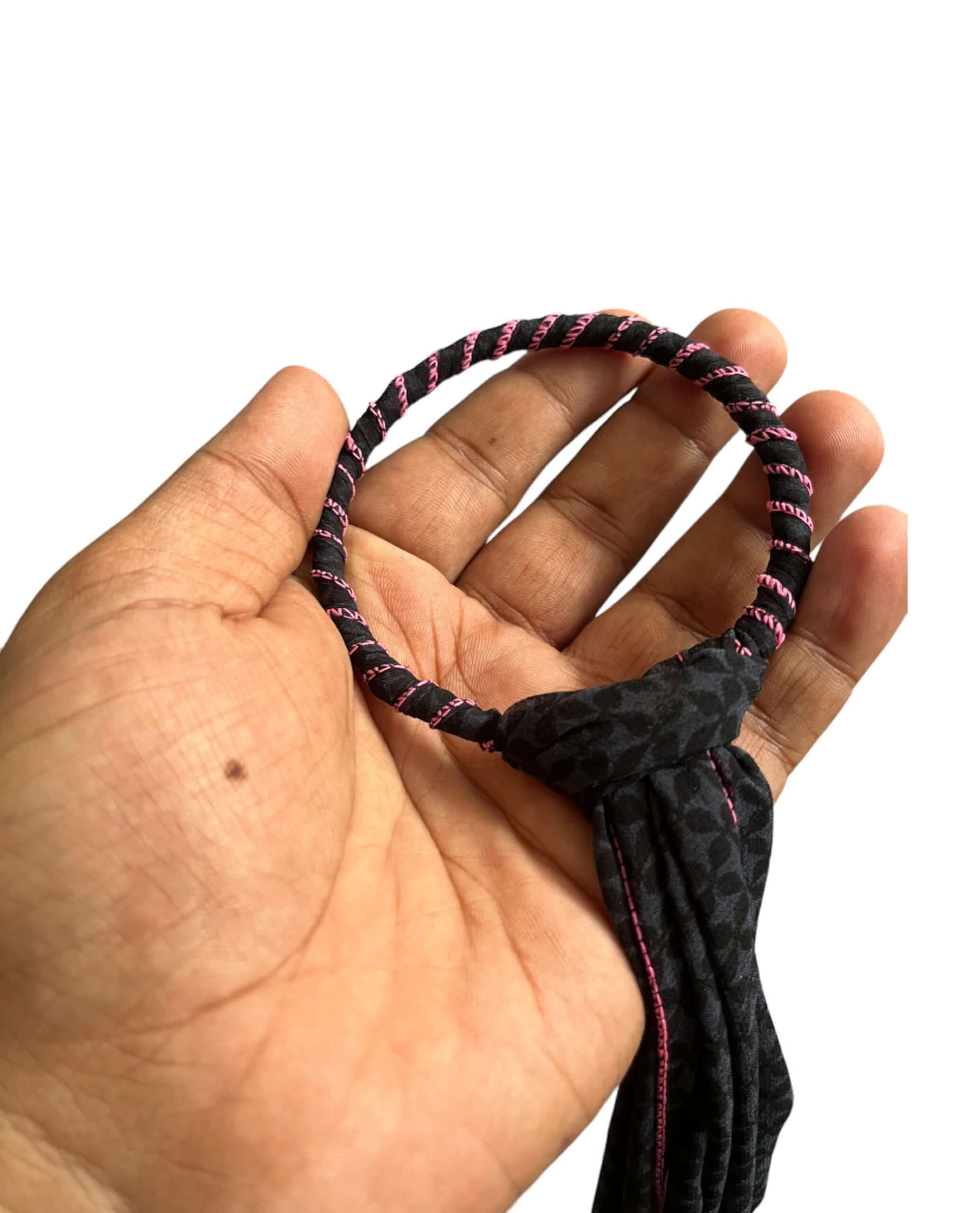 Handcrafted iron metal ring with colorful sari fabric, showcasing a bohemian door hanger accessory.