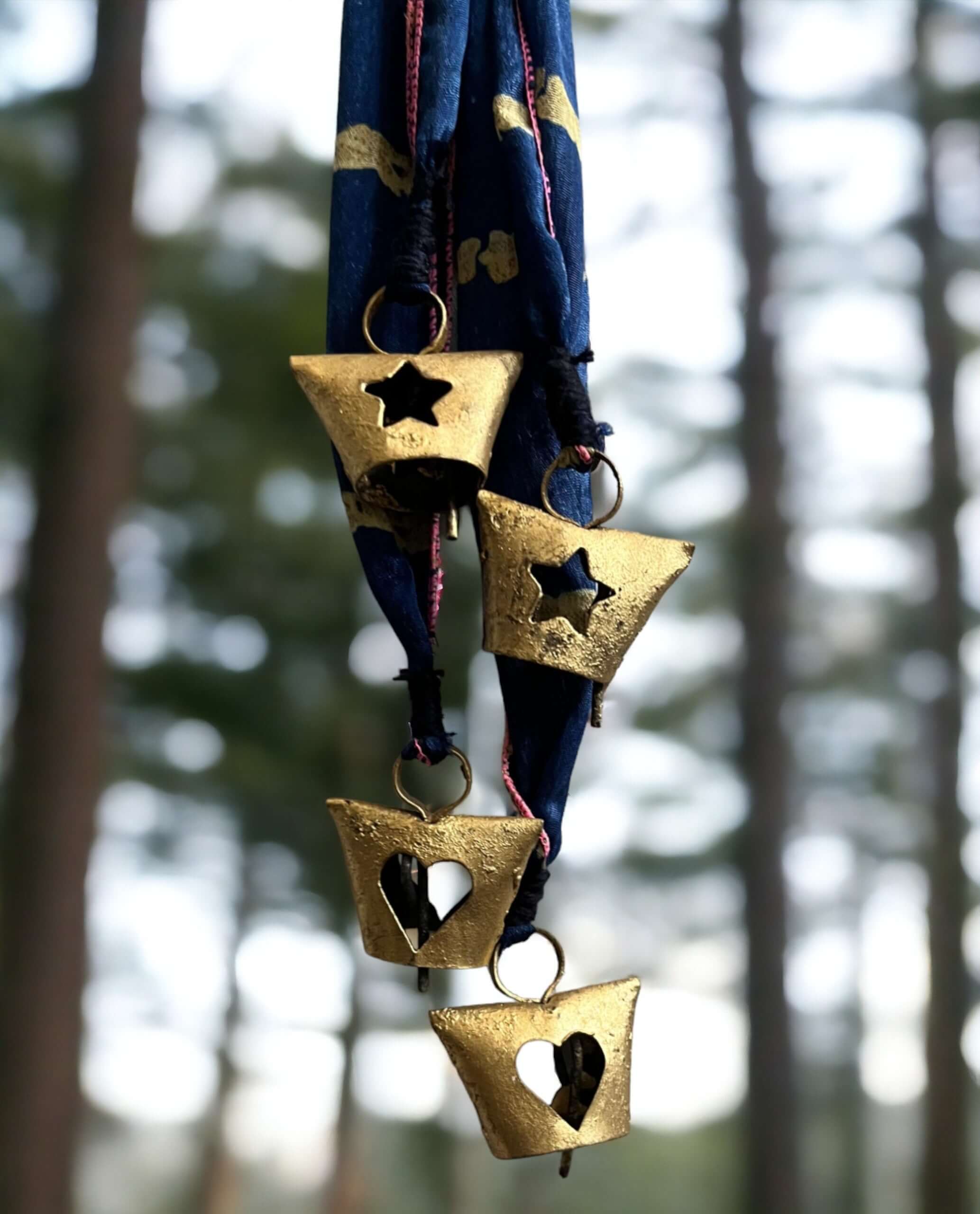 Handmade Evil Eye metal bell ornament with blue Sari ribbon, perfect for holiday decor and bohemian themes.