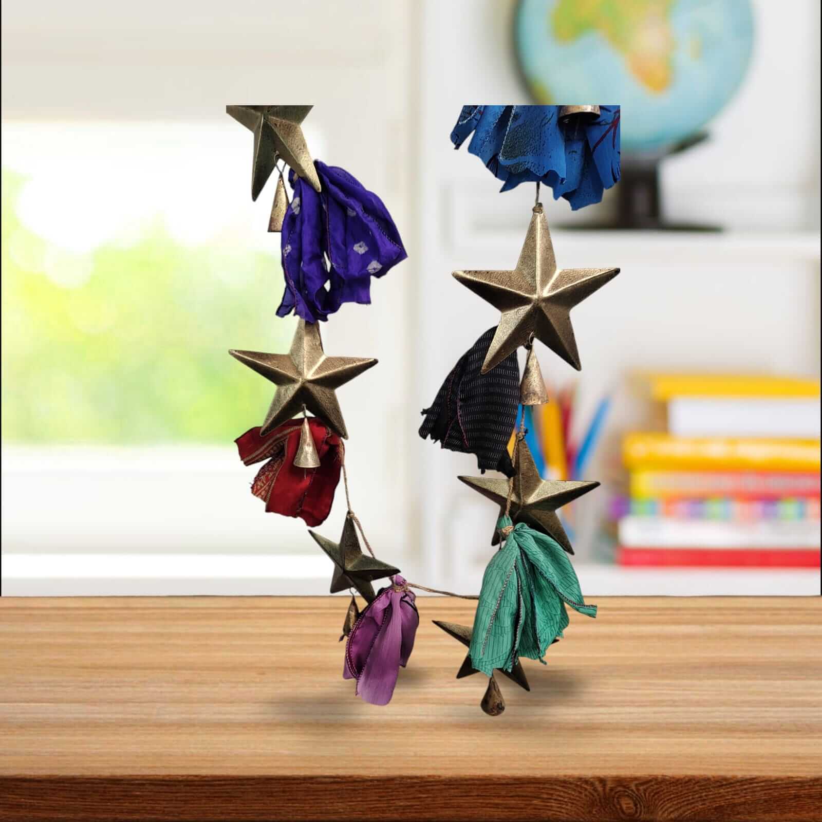 Handmade upcycled silk sari garland with metal stars and colorful fabric, ideal for bohemian holiday decor.