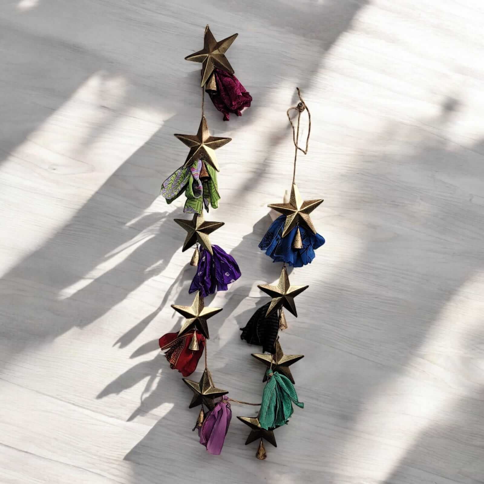 Handmade upcycled silk sari garland with colorful fabric and metal stars, perfect for festive décor and garden decoration.