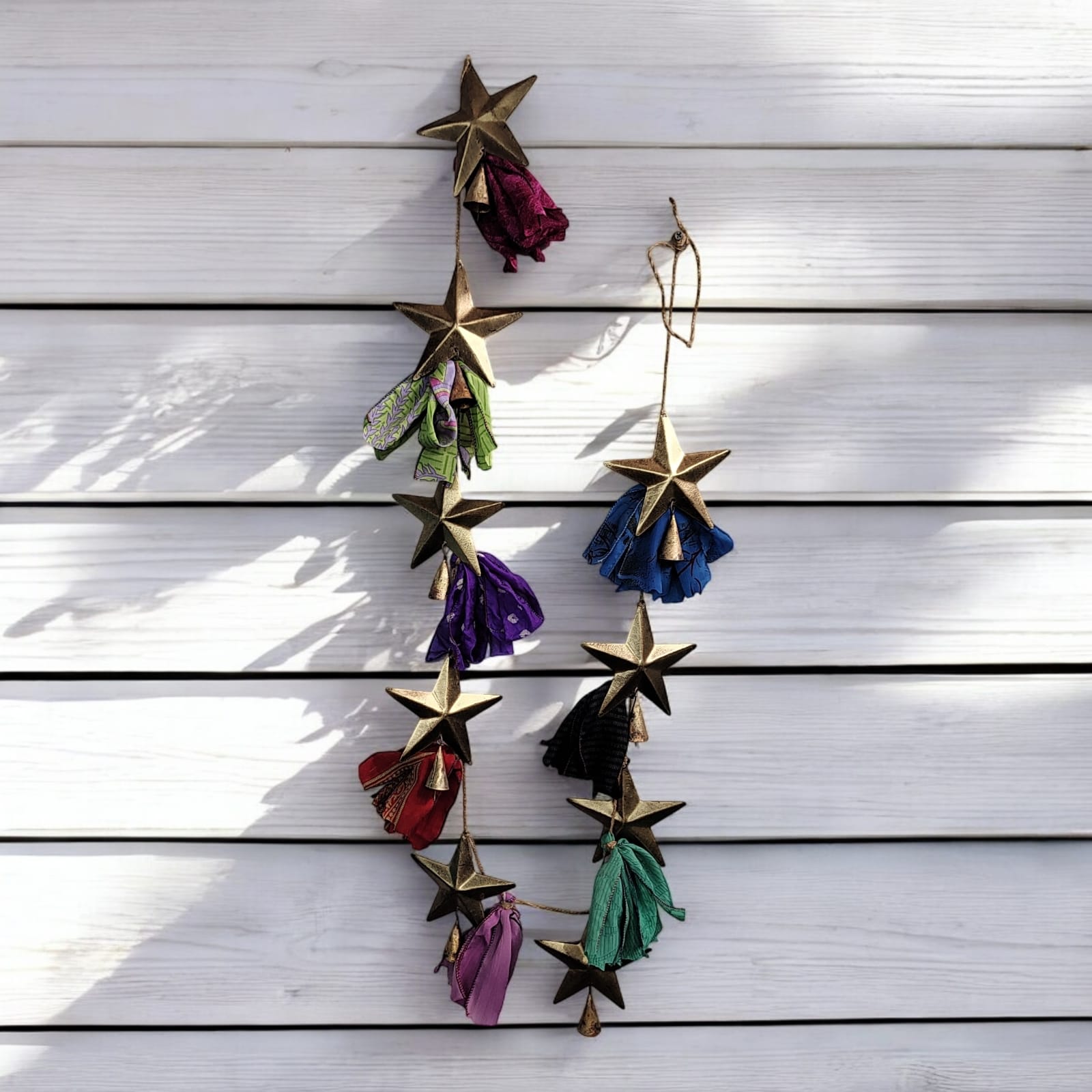 Handmade upcycled silk sari garland with metal stars and bells, bohemian decoration for indoor and outdoor use.